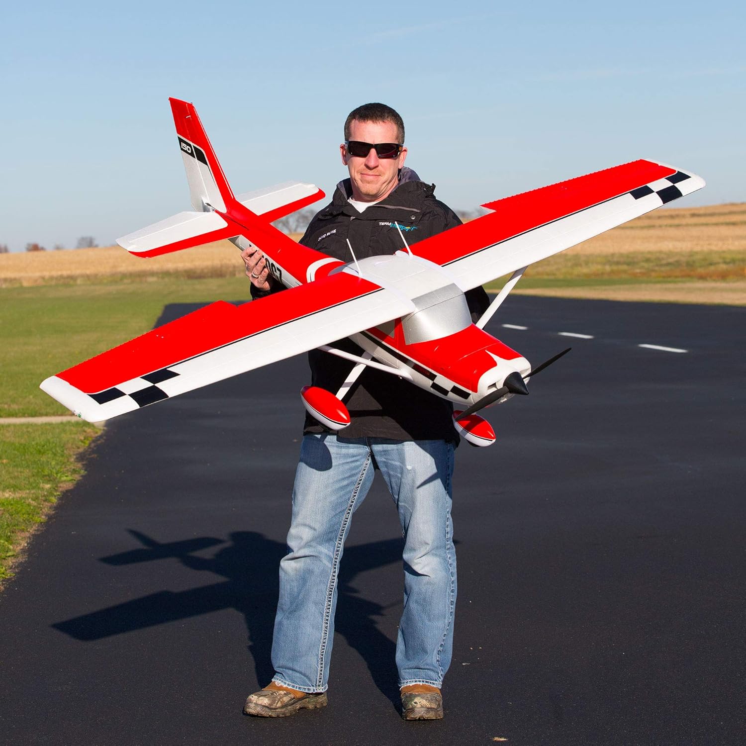 Person holding the E-flite Carbon-Z Cessna 150 2.1M RC Airplane, showing its large size