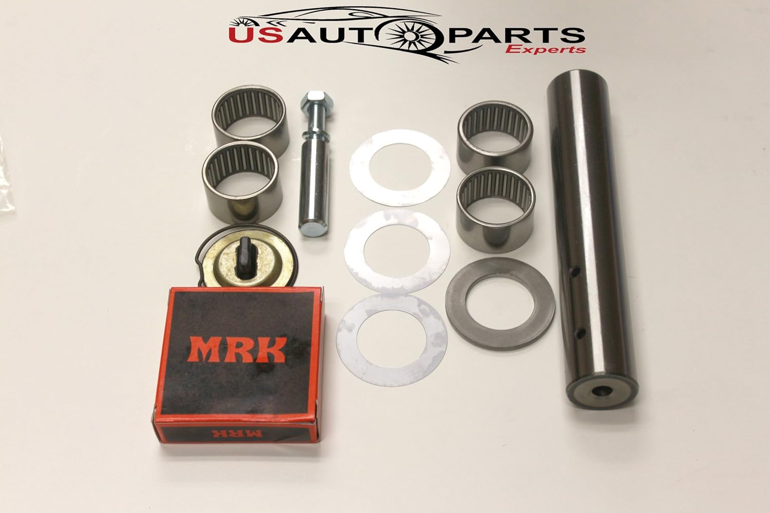 Another view of the King Pin Kit components, showing the main king pin, four bushings, a bolt, and several washers of different sizes.