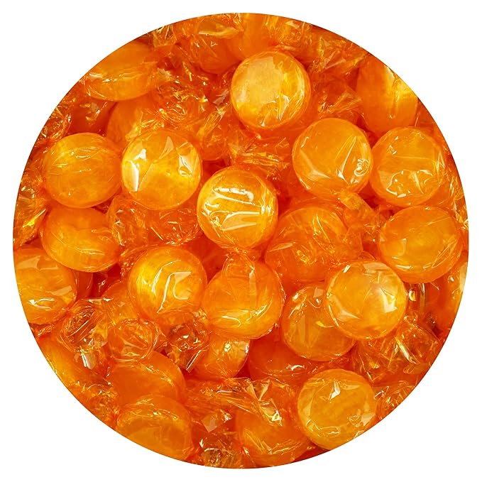 Pile of butterscotch hard candies, individually wrapped in plastic.