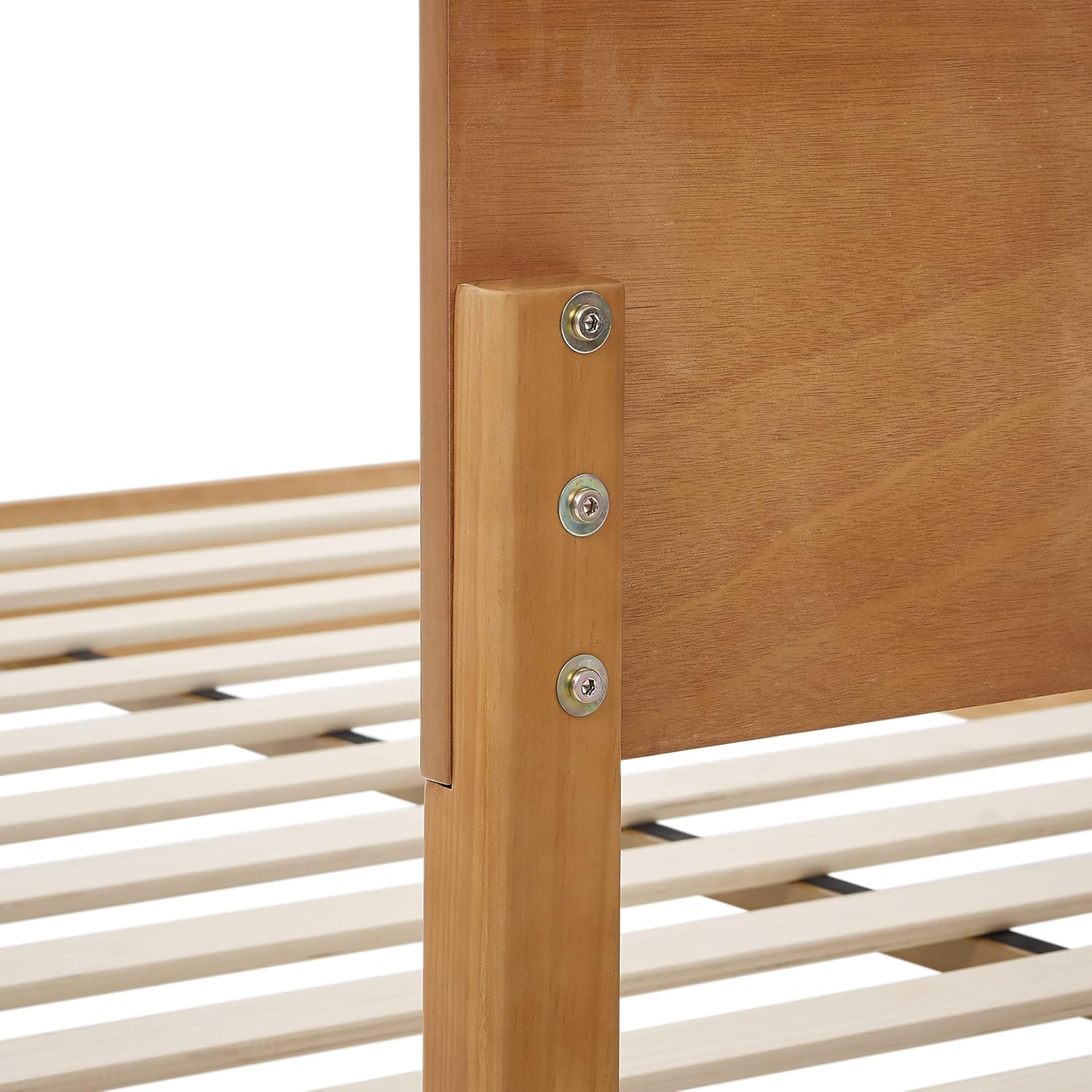 Close-up of the headboard attachment point, showing bolts securing the headboard to the frame