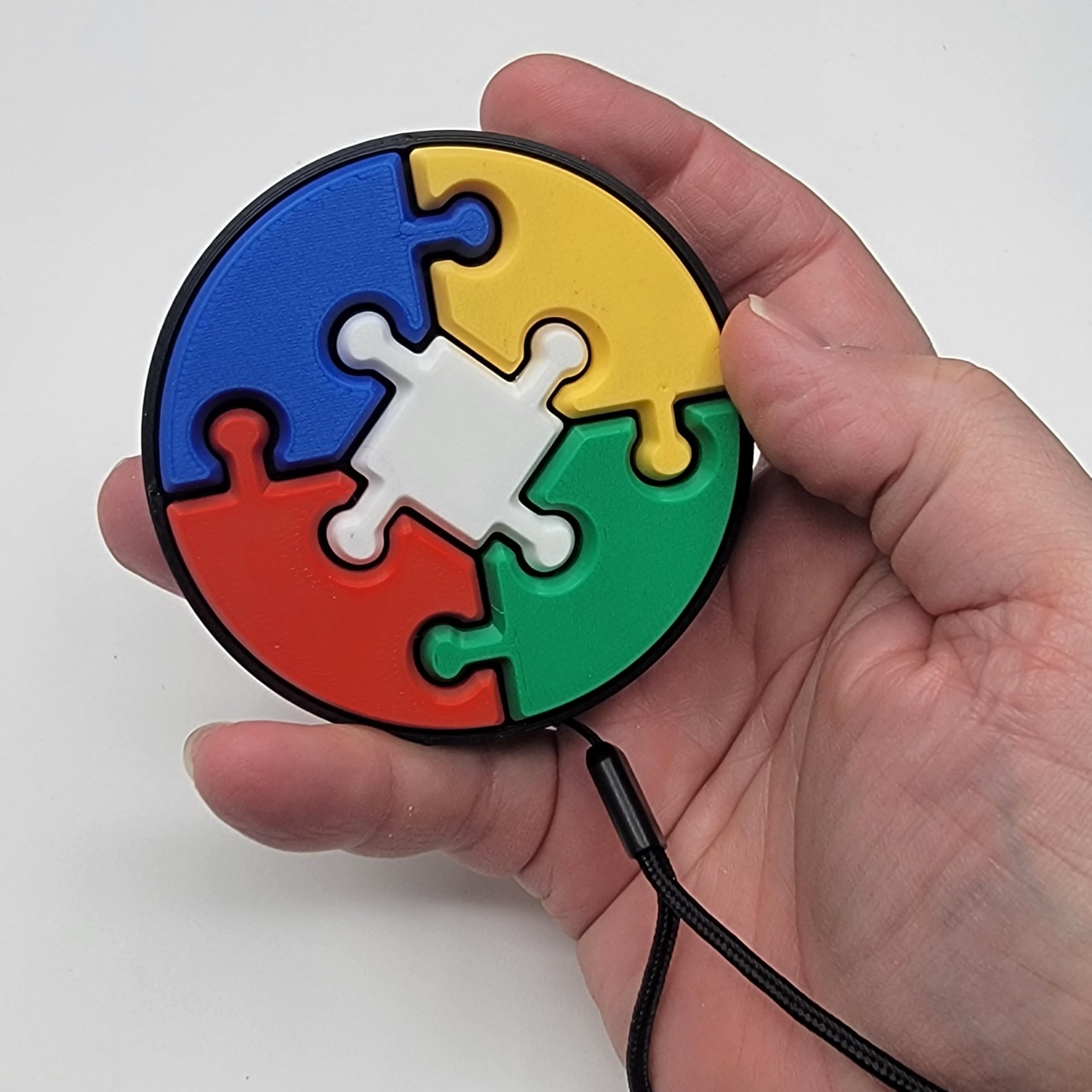 Sensory Puzzle Clicker Toy, 3 Inch Circle with 5 Colored Pieces, Pocket Friendly, Black Wristlet