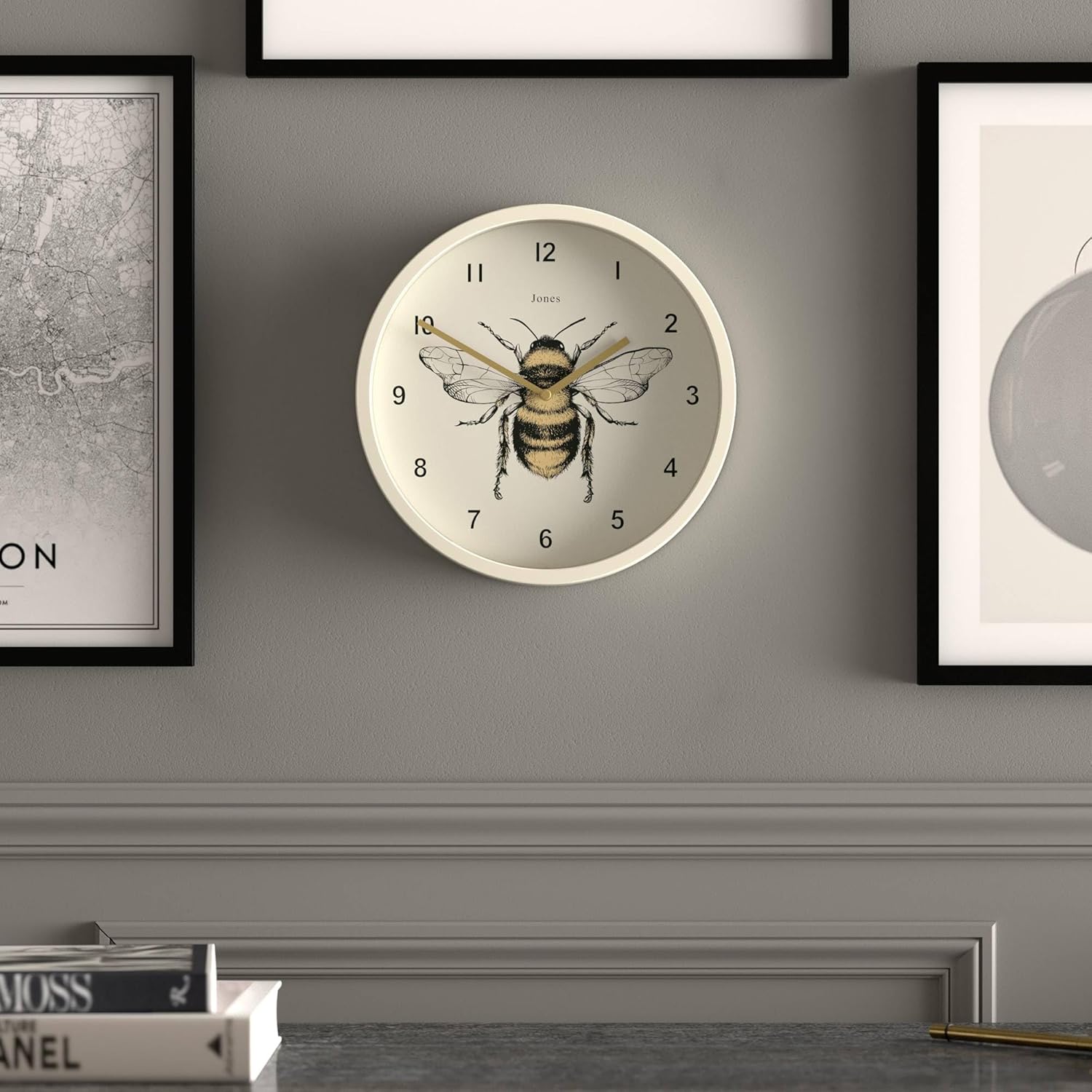 JONES CLOCKS Bee Wall Clock mounted on a grey wall above a desk