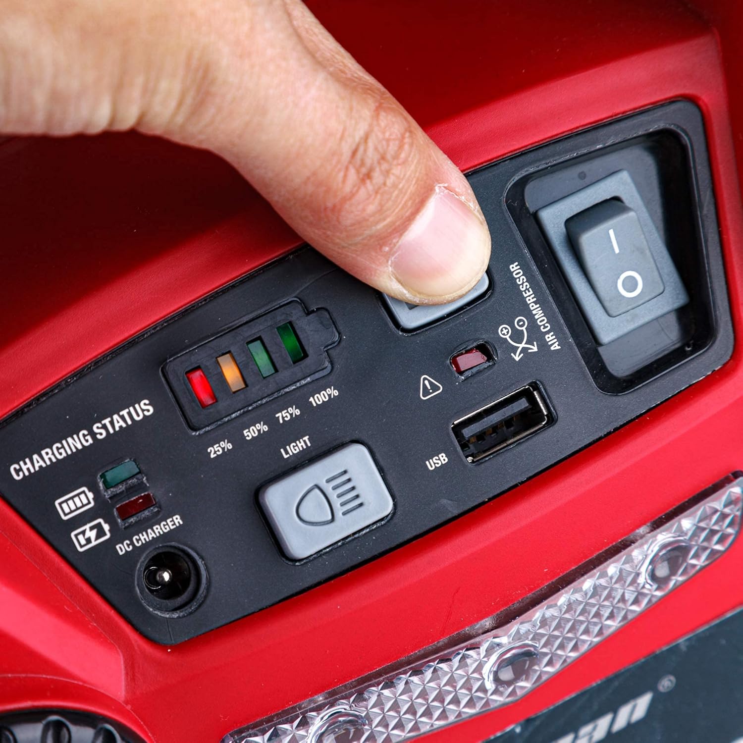 Close-up of the control panel showing battery charging status LEDs and USB port