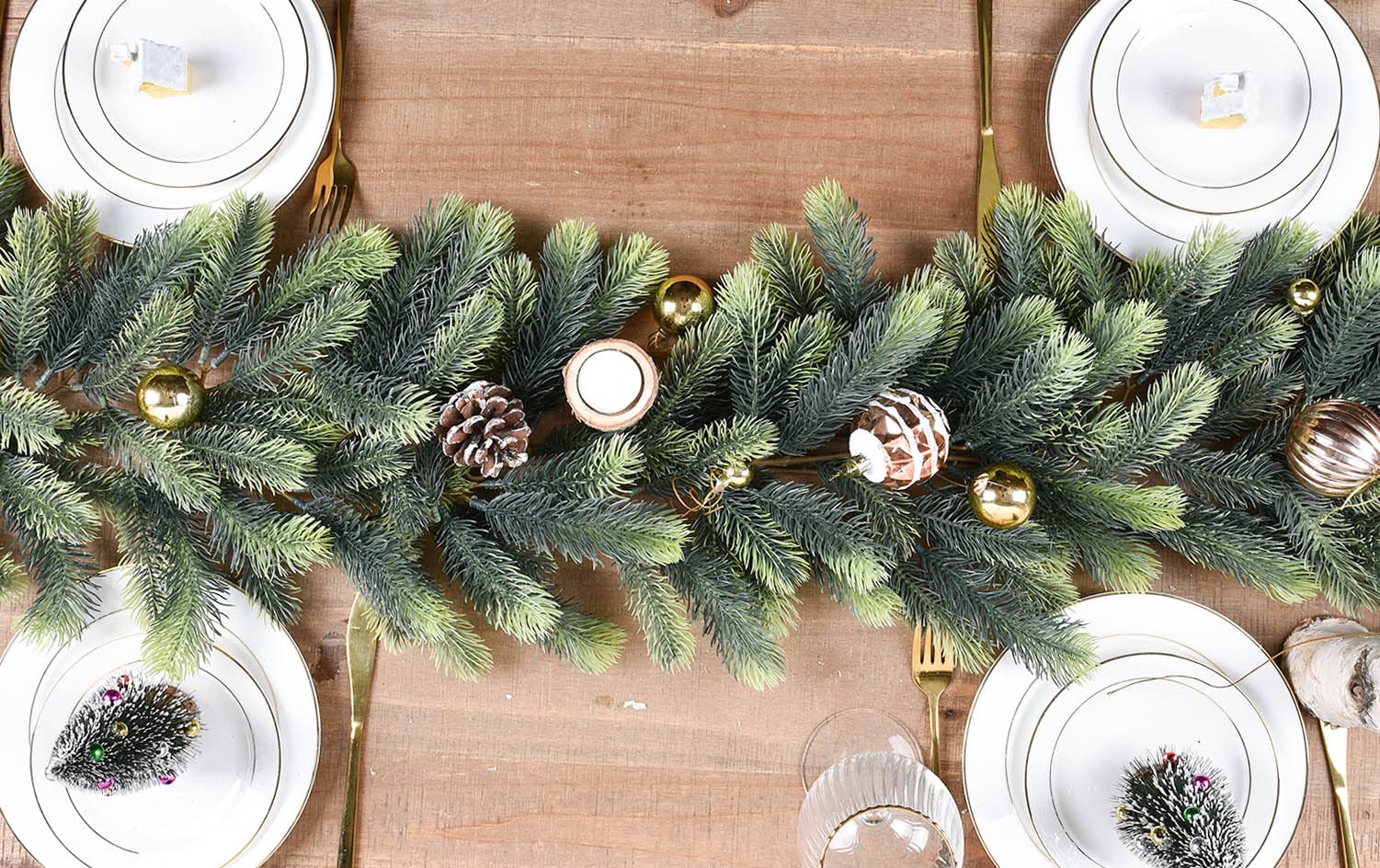Pine garland and small tree decorating a holiday entryway.