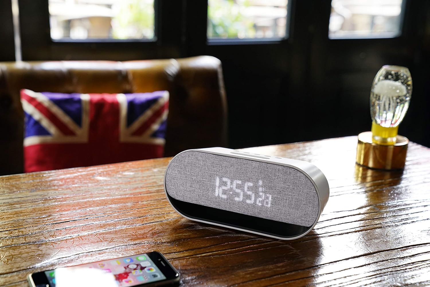 Oregon Scientific CIR600 on a wooden table next to a smartphone, illustrating Bluetooth connectivity.