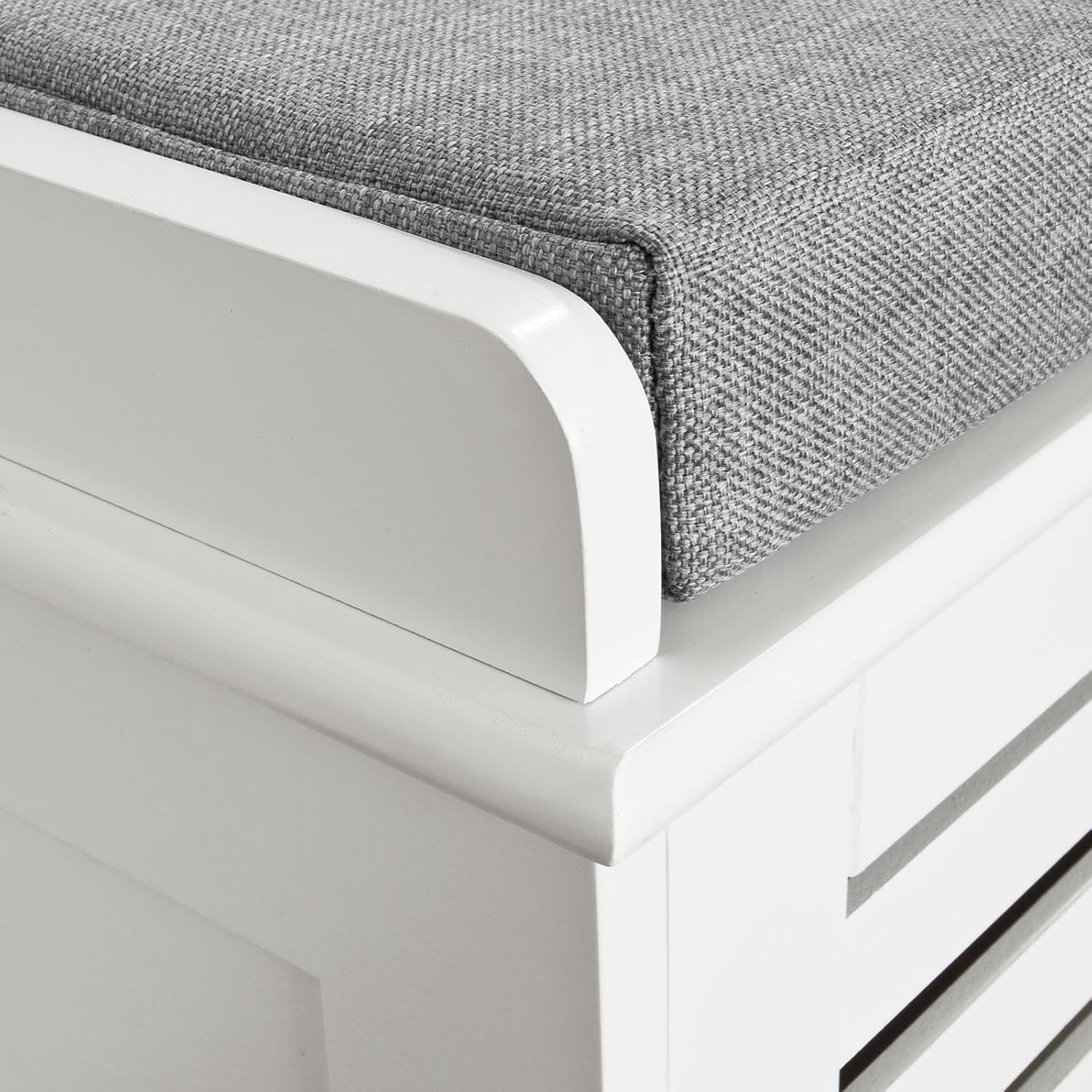 Close-up of the grey fabric cushion and white wooden frame of the SoBuy FSR23-K-W shoe bench.