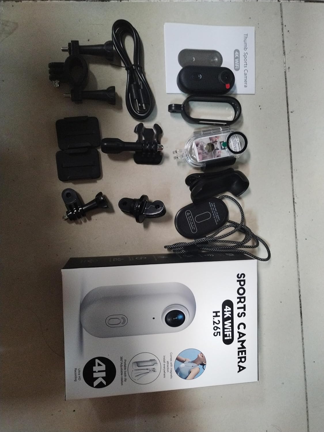 Image showing all included accessories and the camera laid out on a surface, including the product box.