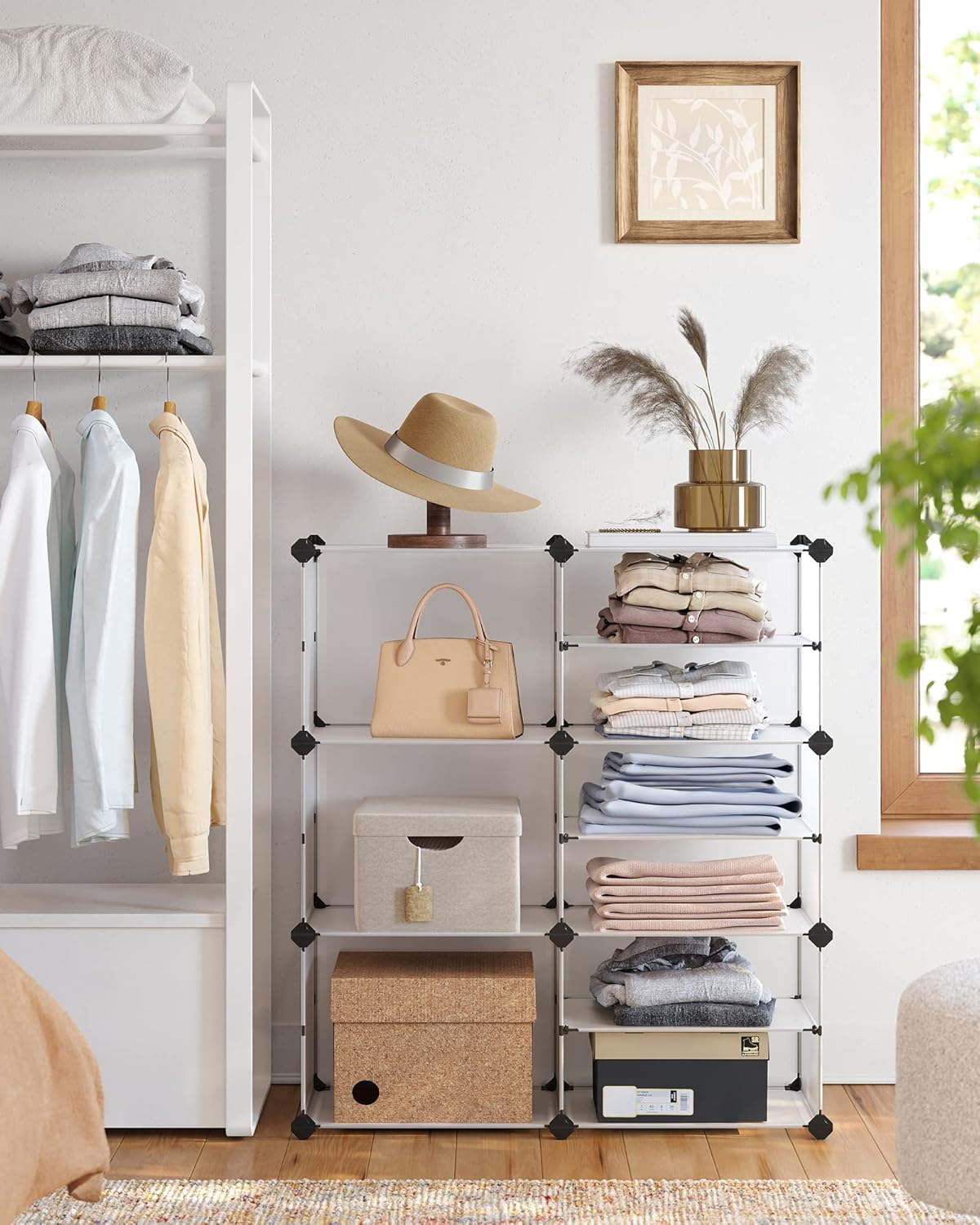 SONGMICS Modular Storage Unit in a bedroom setting, used to store folded clothes, a handbag, and decorative items.