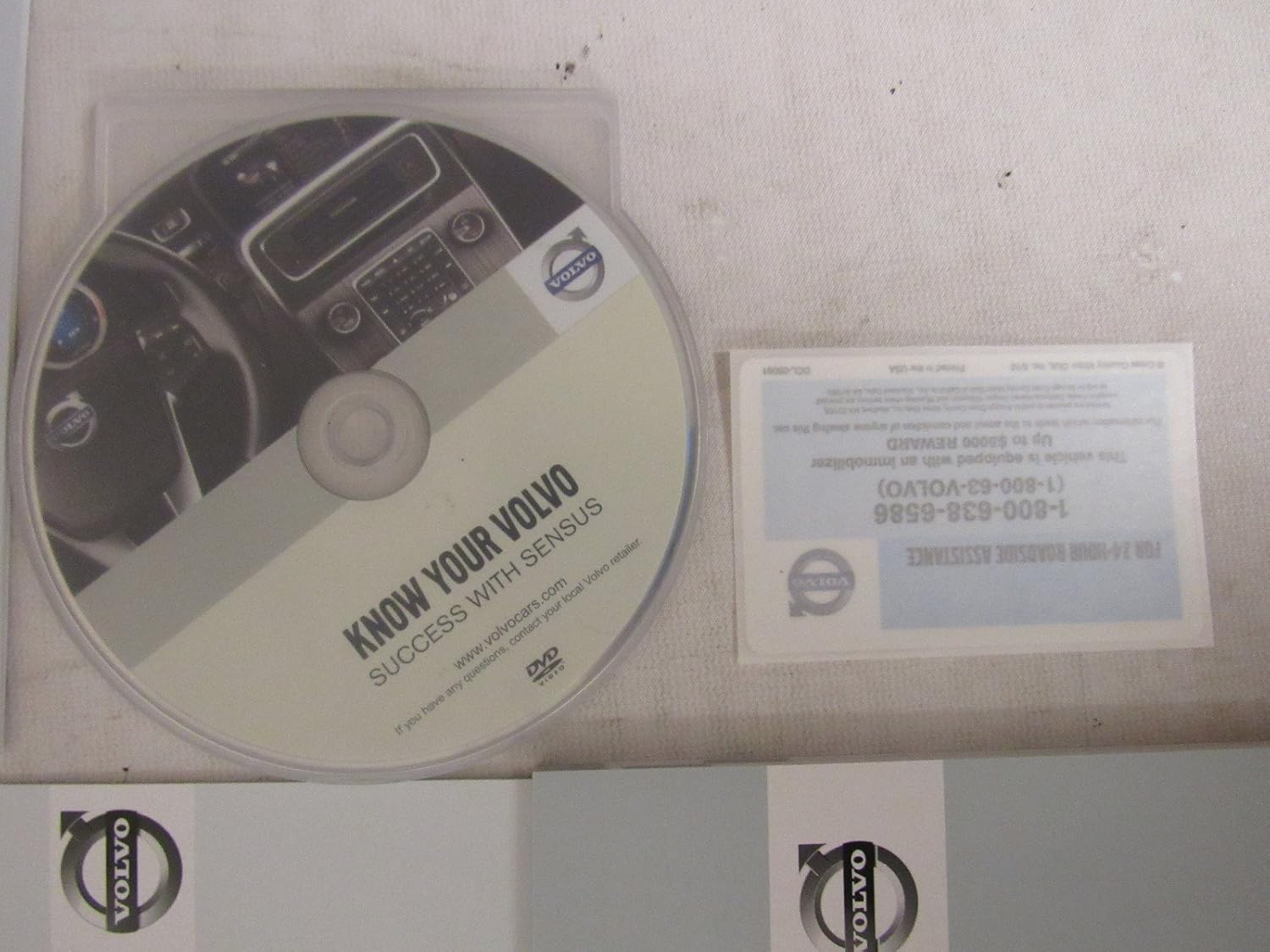 Volvo immobilizer warning card with roadside assistance number.