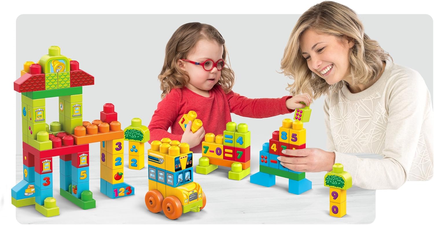Child and adult playing with Mega Bloks Build 'n Learn Math set, featuring a school, bus, and math equation blocks.