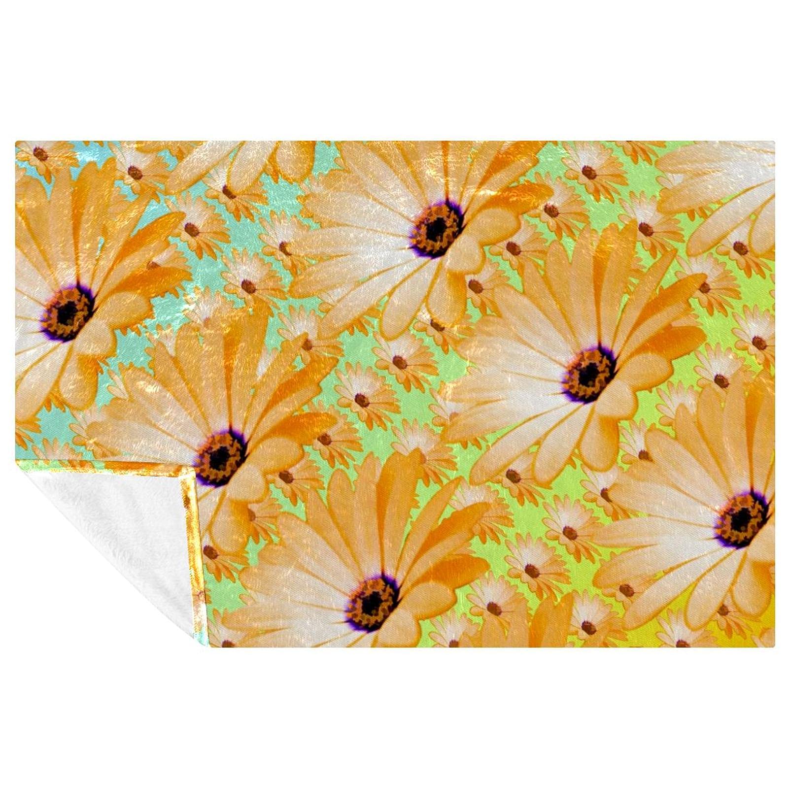 Couverture chaude verte et jaune motif marguerites pour créer un cocon cosy au salon