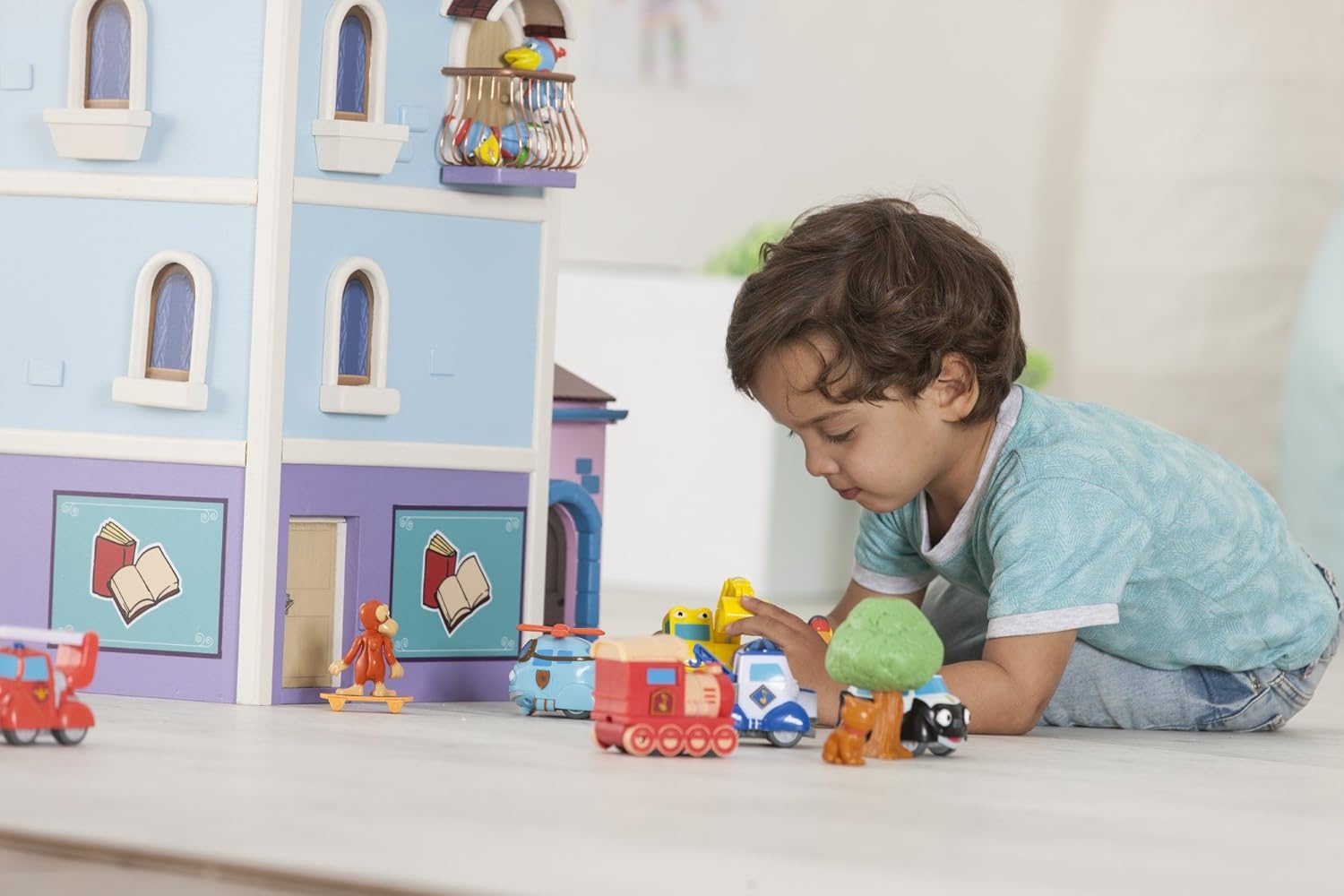 Child playing with Dickie Toys Heroes of The City figures and other toys