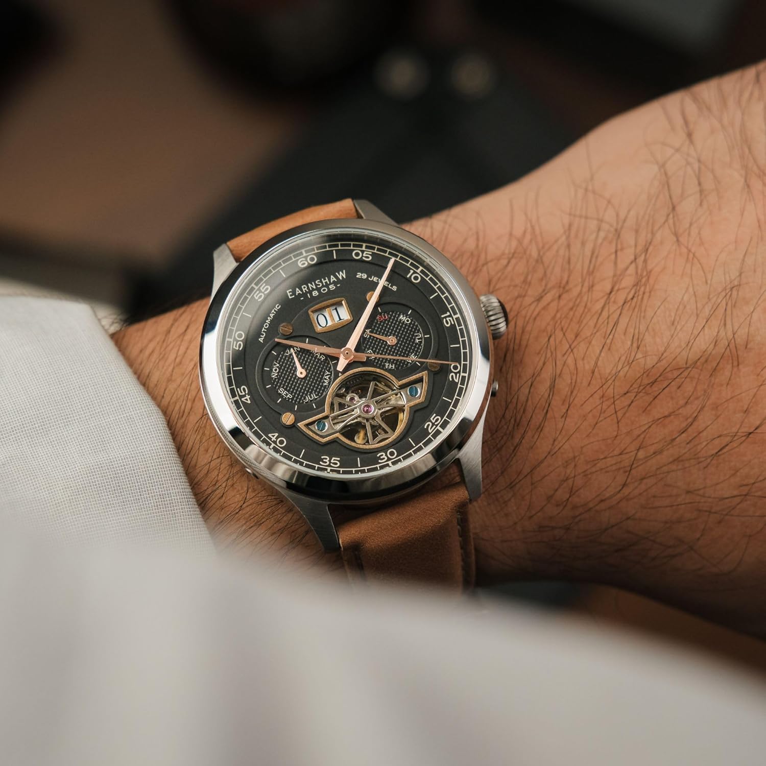 Thomas Earnshaw Baron watch on a wrist, showing the open-heart movement