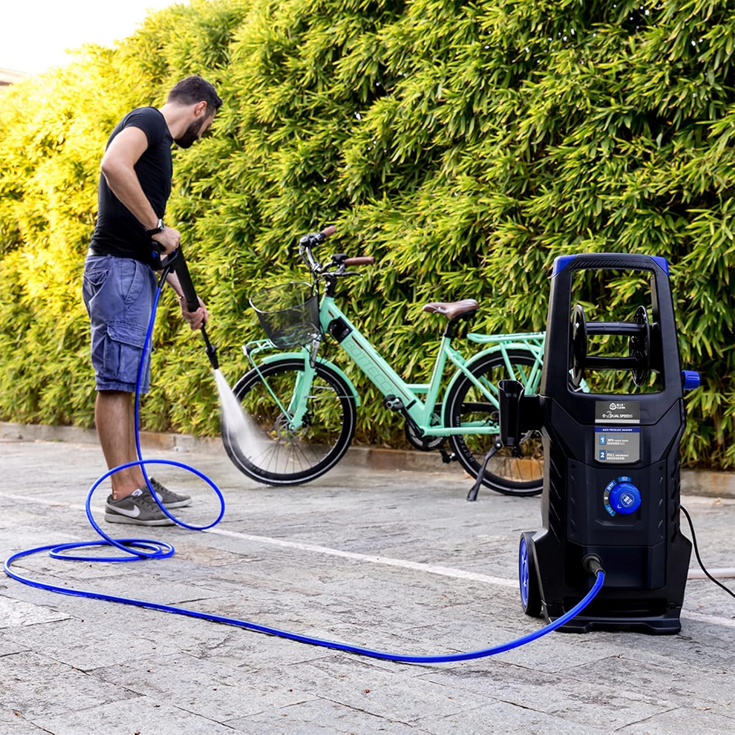 Person cleaning a bicycle with the pressure washer in ECO SPEED mode