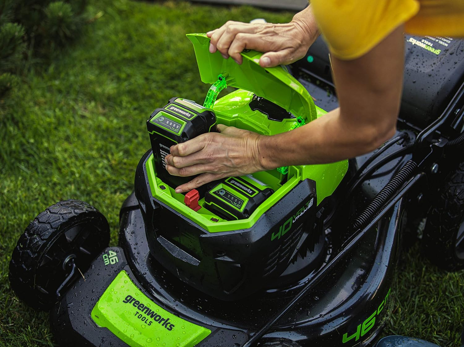 Inserting battery into Greenworks lawn mower
