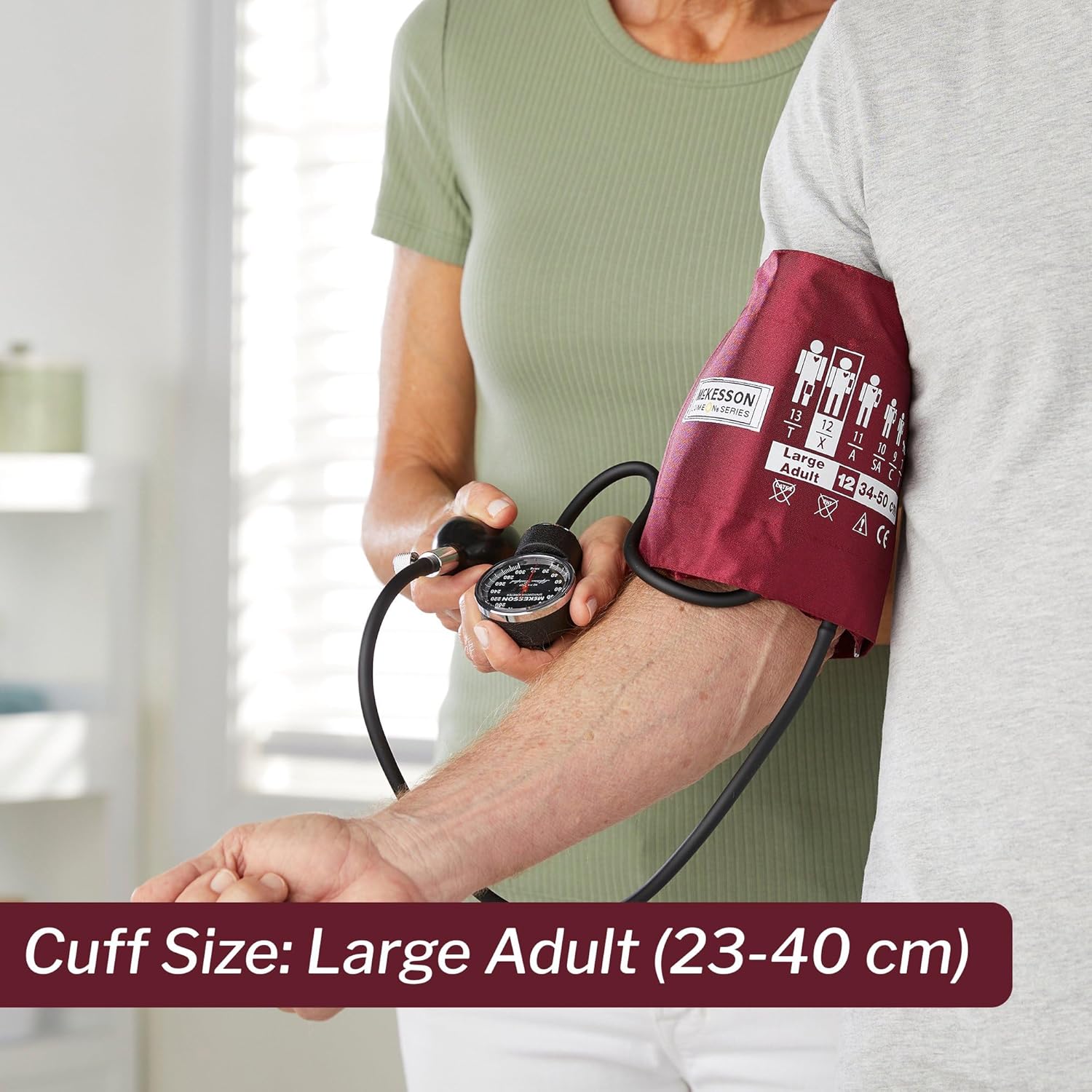 Person using a McKesson Aneroid Sphygmomanometer to measure blood pressure