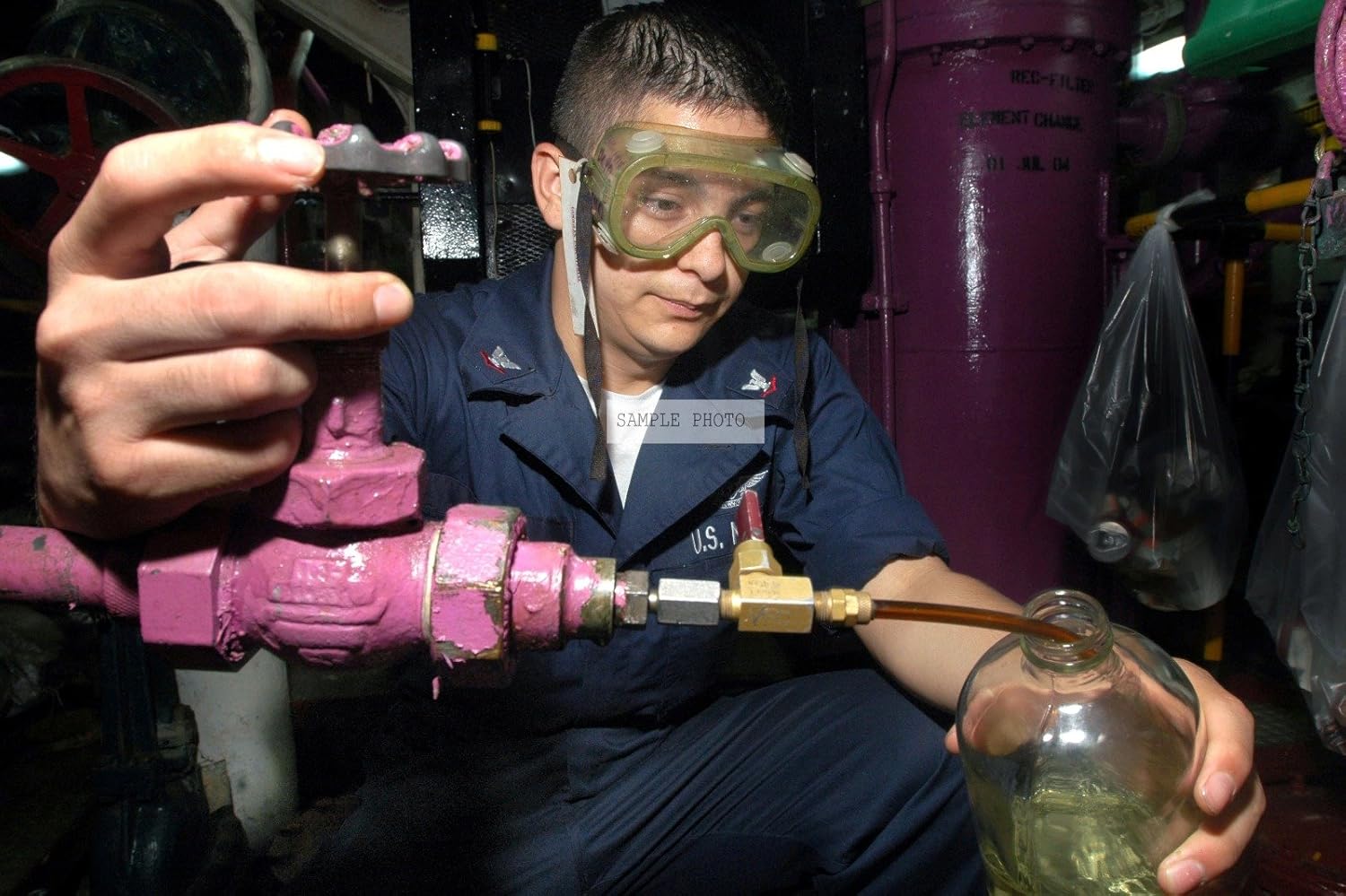 Photo U.S. Navy Aviation Boatswain's Mate Fuels 3rd Class Juan Sosa takes a sample