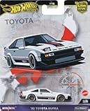 Premium Car Culture Collectible Toy Car, 1:64 Scale Die-Cast '82 Toyota Supra, World Tour Vehicle with Real Riders Tires