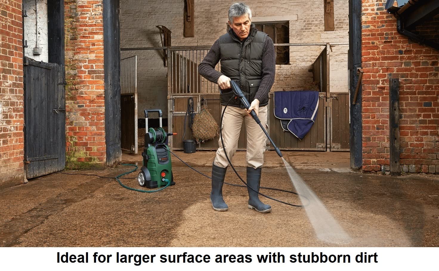Man cleaning outdoor steps with pressure washer