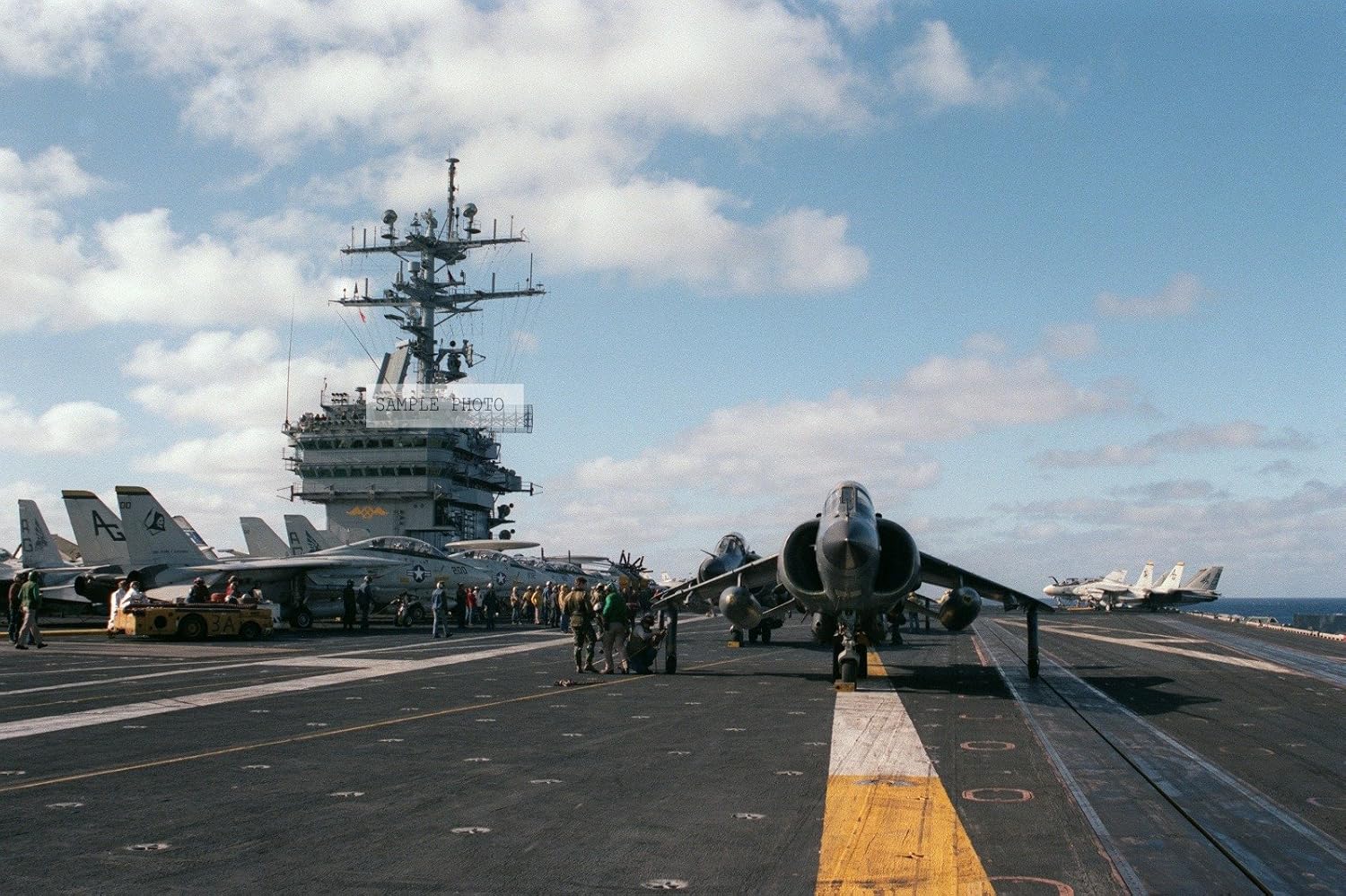 Photo Flight deck crewmen release the tie down chains from a British Royal Navy FRS