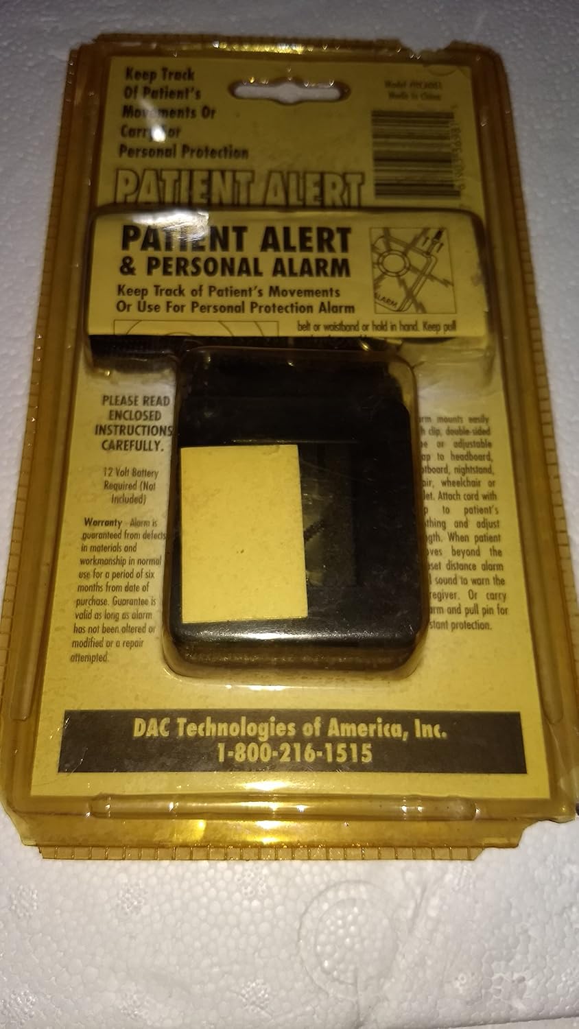 Back of DAC Patient Alert & Personal Alarm packaging showing battery information