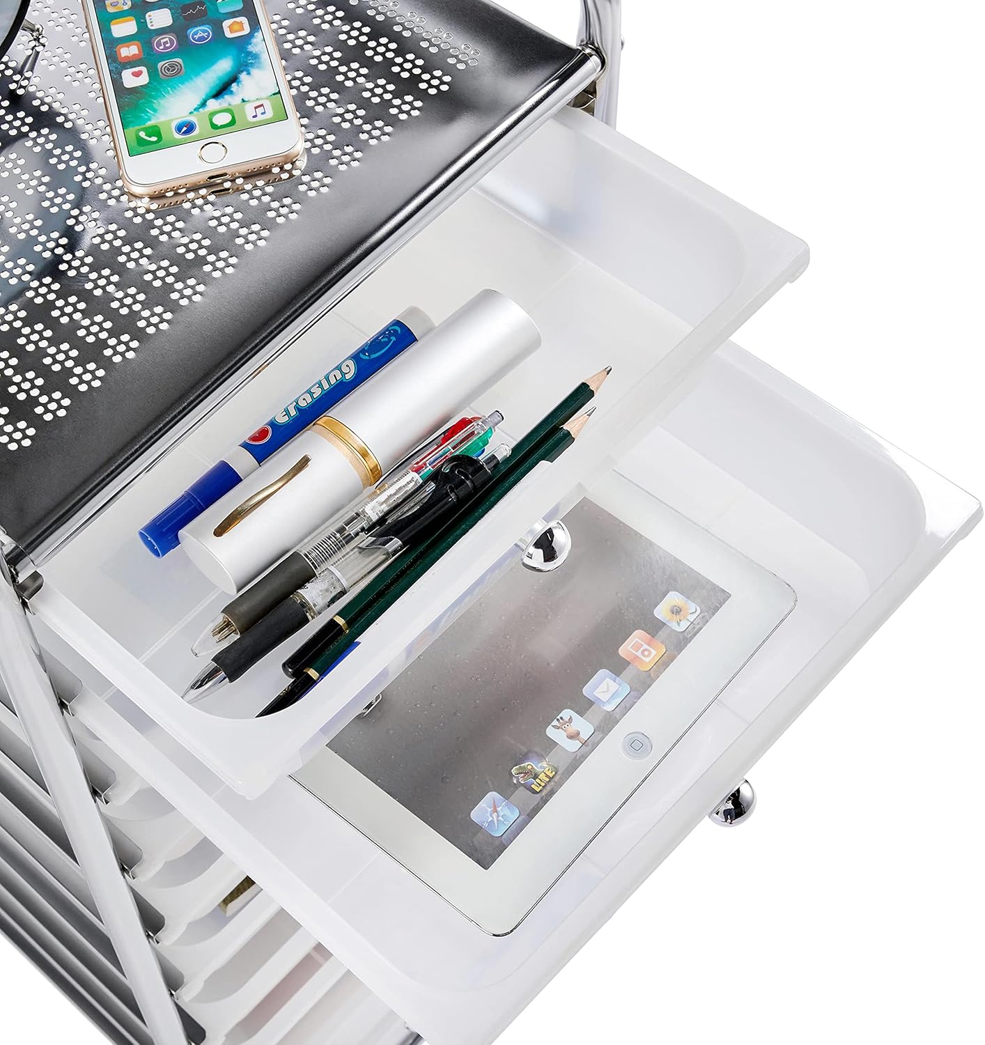 Close-up of a drawer filled with pens and a tablet