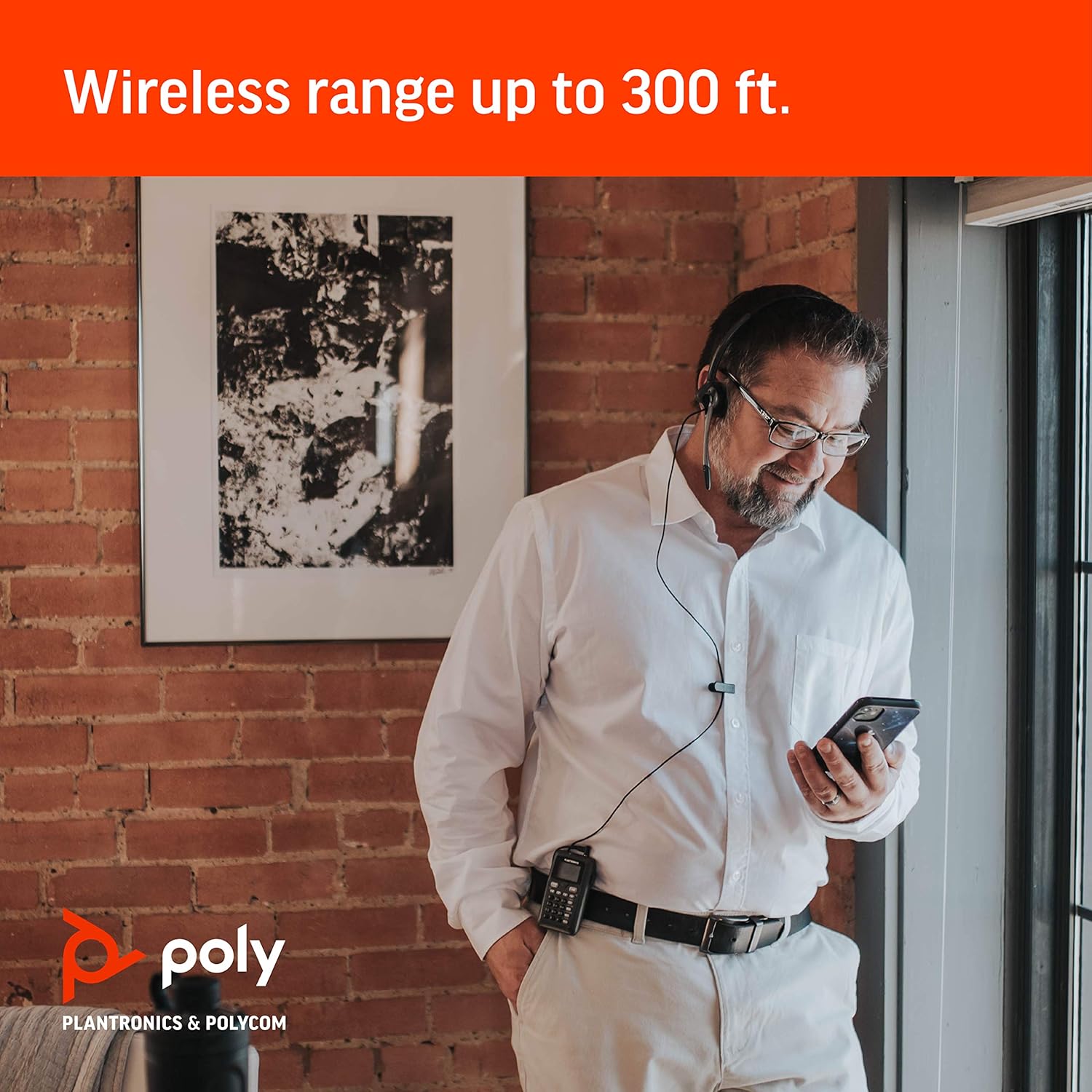 A man wearing the Plantronics CT14 headset and dial pad, demonstrating the wireless range.