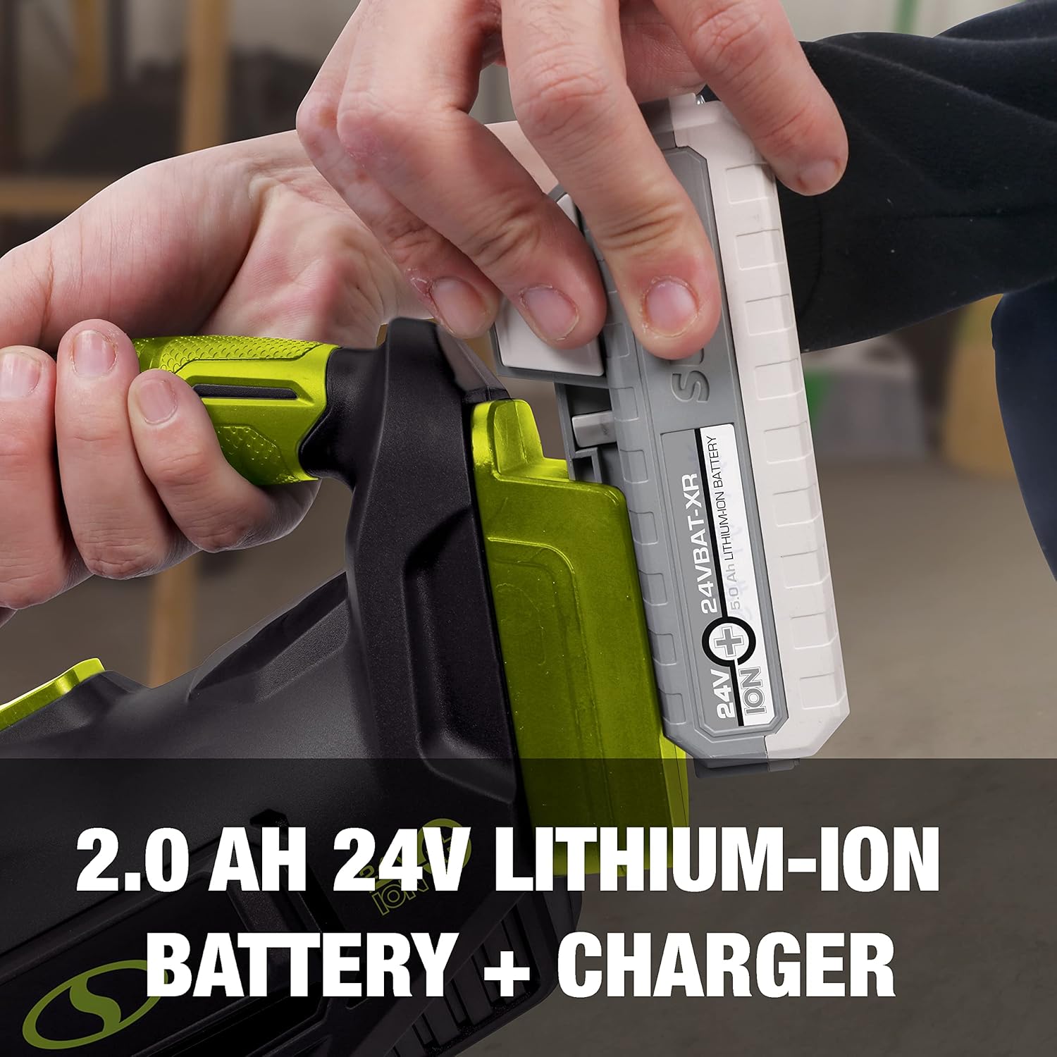 Hand inserting a 24V lithium-ion battery into the Auto Joe handheld vacuum.