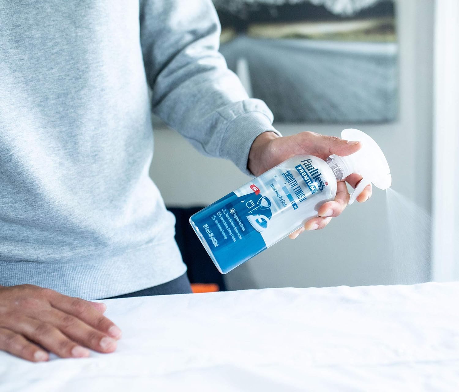 Hand spraying Faultless starch onto fabric