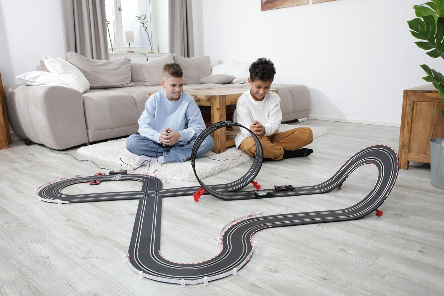 Two children playing with the Carrera GO!!! Max Performance slot car track.