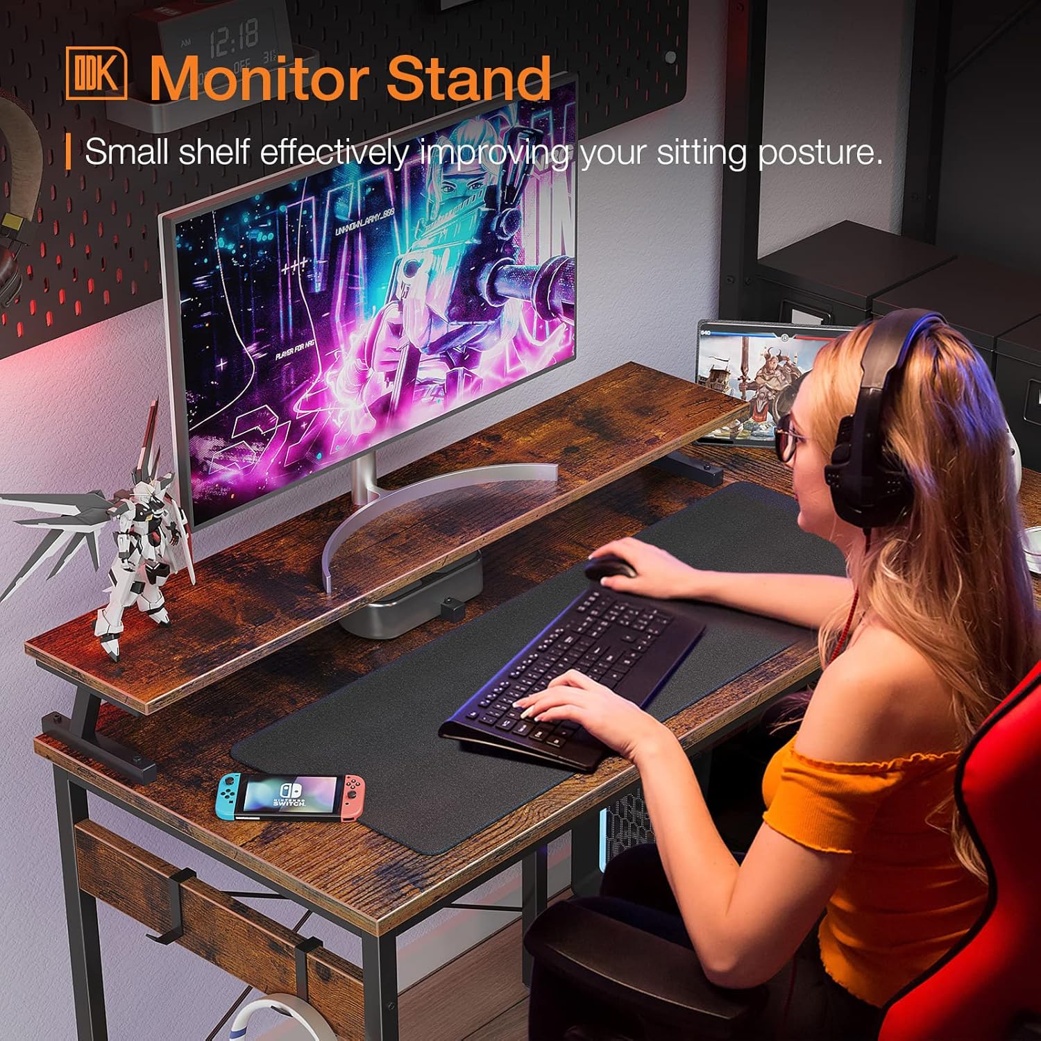 User working at the ODK L-shaped desk with an elevated monitor stand