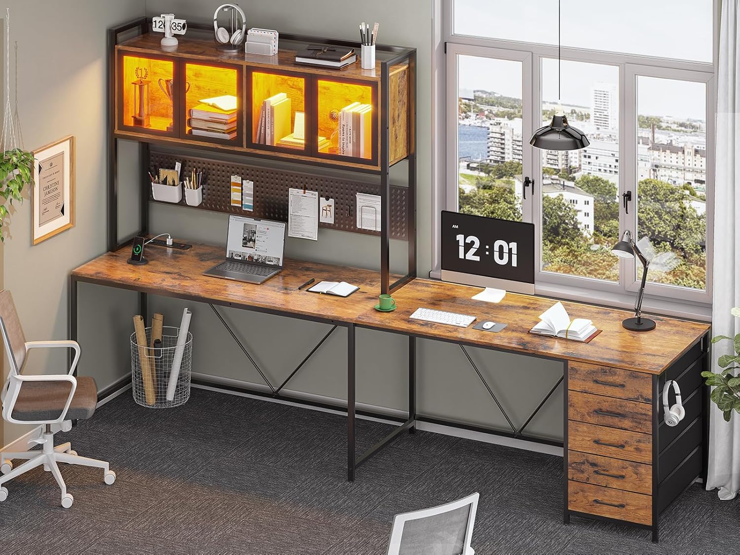 The display cabinet with internal LED lights illuminating various decorative items, showing both gaming and working setups.
