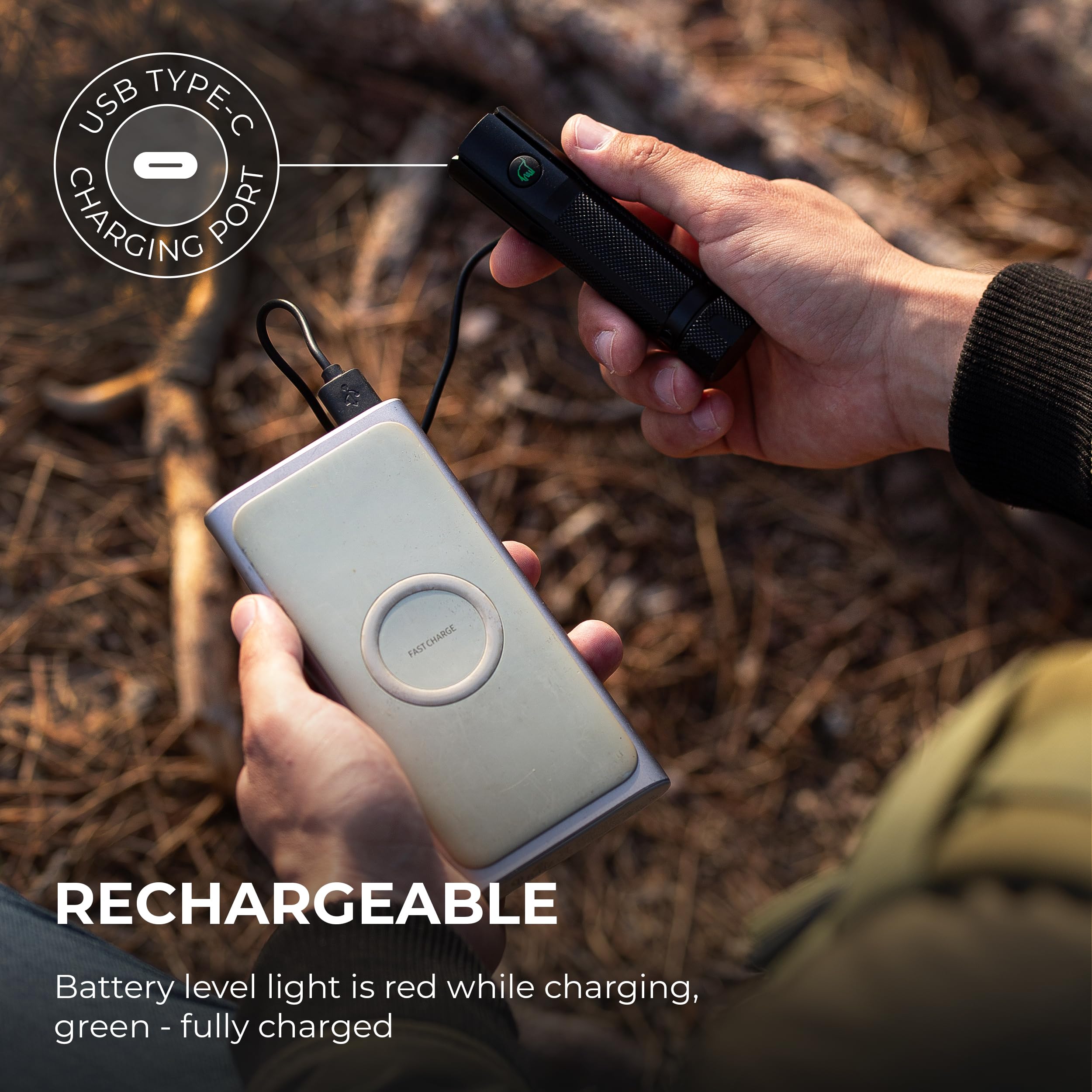 Hands plugging a USB Type-C cable into the flashlight for charging, with a power bank in the background.