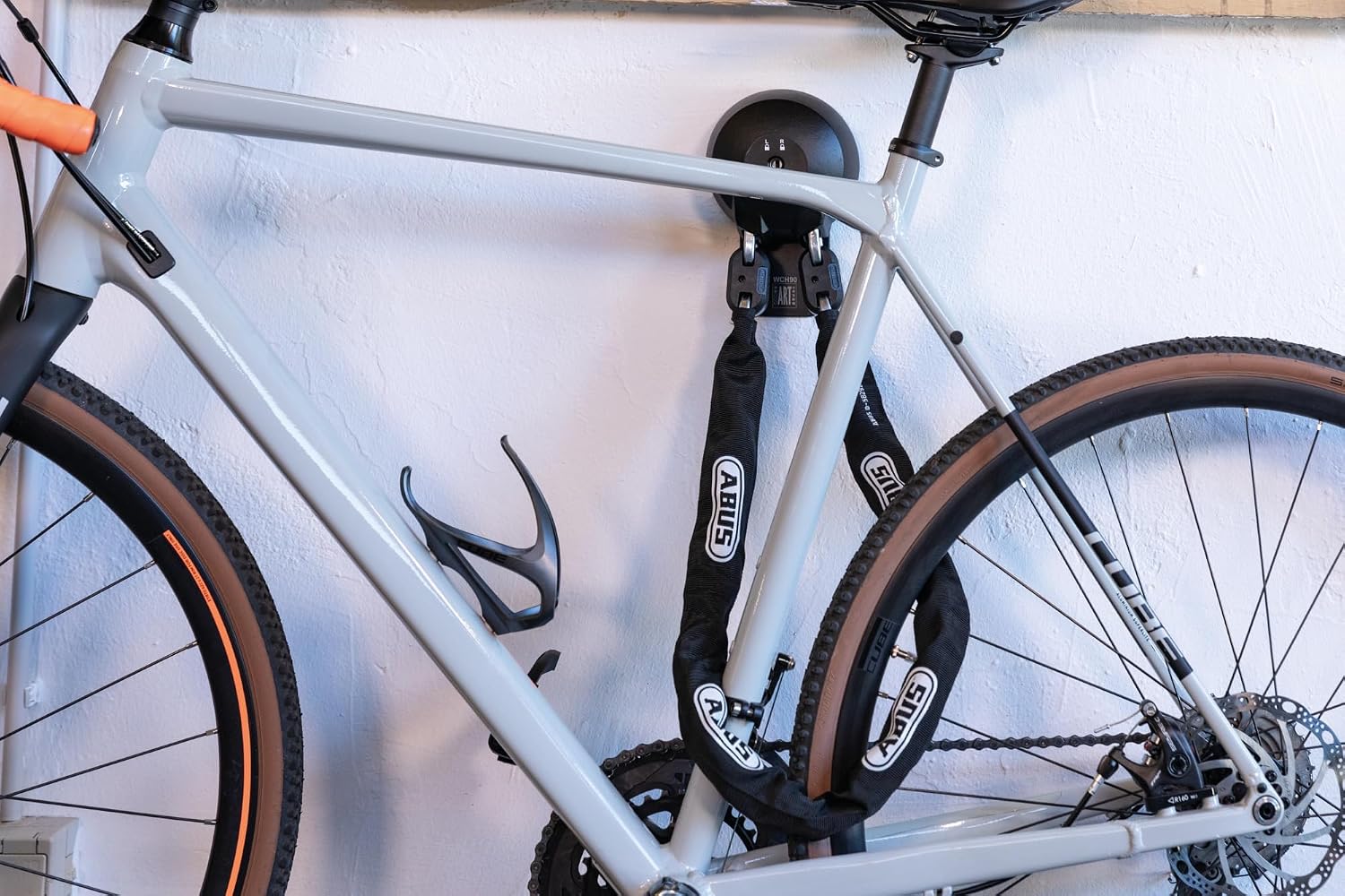 Bicycle secured to an ABUS Wall Anchor with a chain lock.