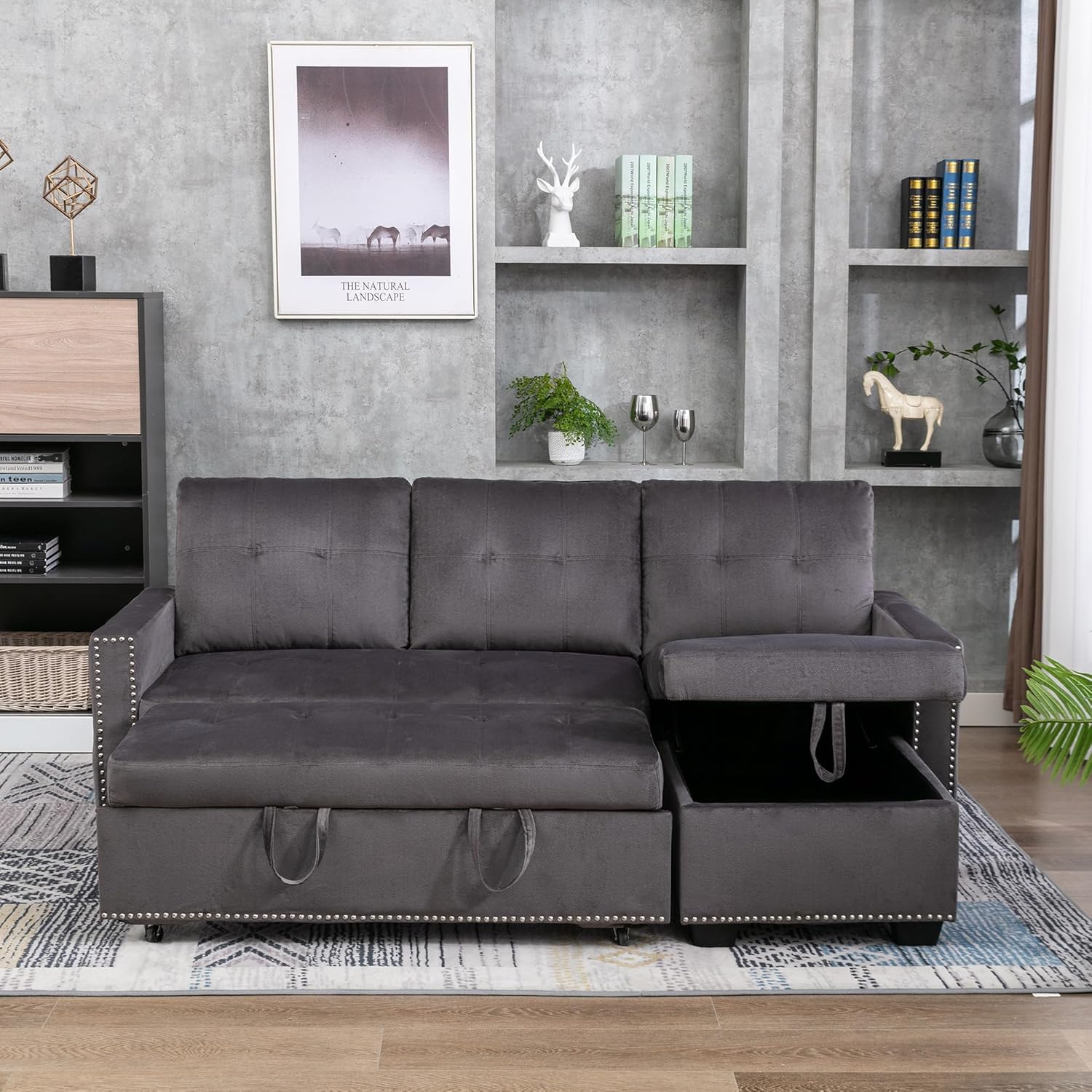 Polibi sectional sofa bed in dark grey, with the pull-out sleeper extended and the chaise storage compartment open.