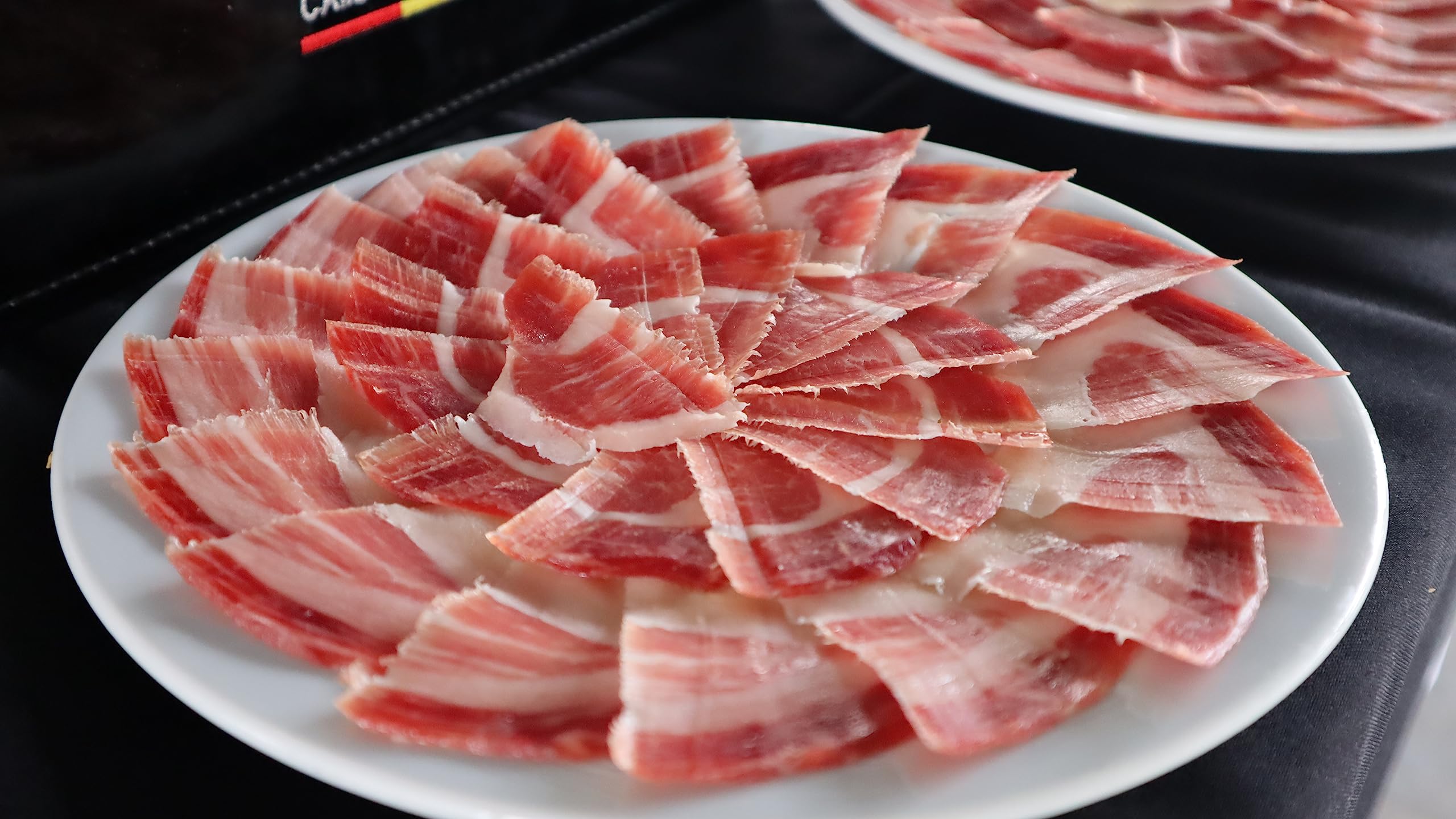 Corsevilla - Confezione di Jamón Ibérico di Bellota a Fette 100% - Spalla affettata 100% iberica di bellota - Prosciutto Crudo - Prosciutto Pata negra - Salumi - 12 pezzi - 100 grammi per confezione.