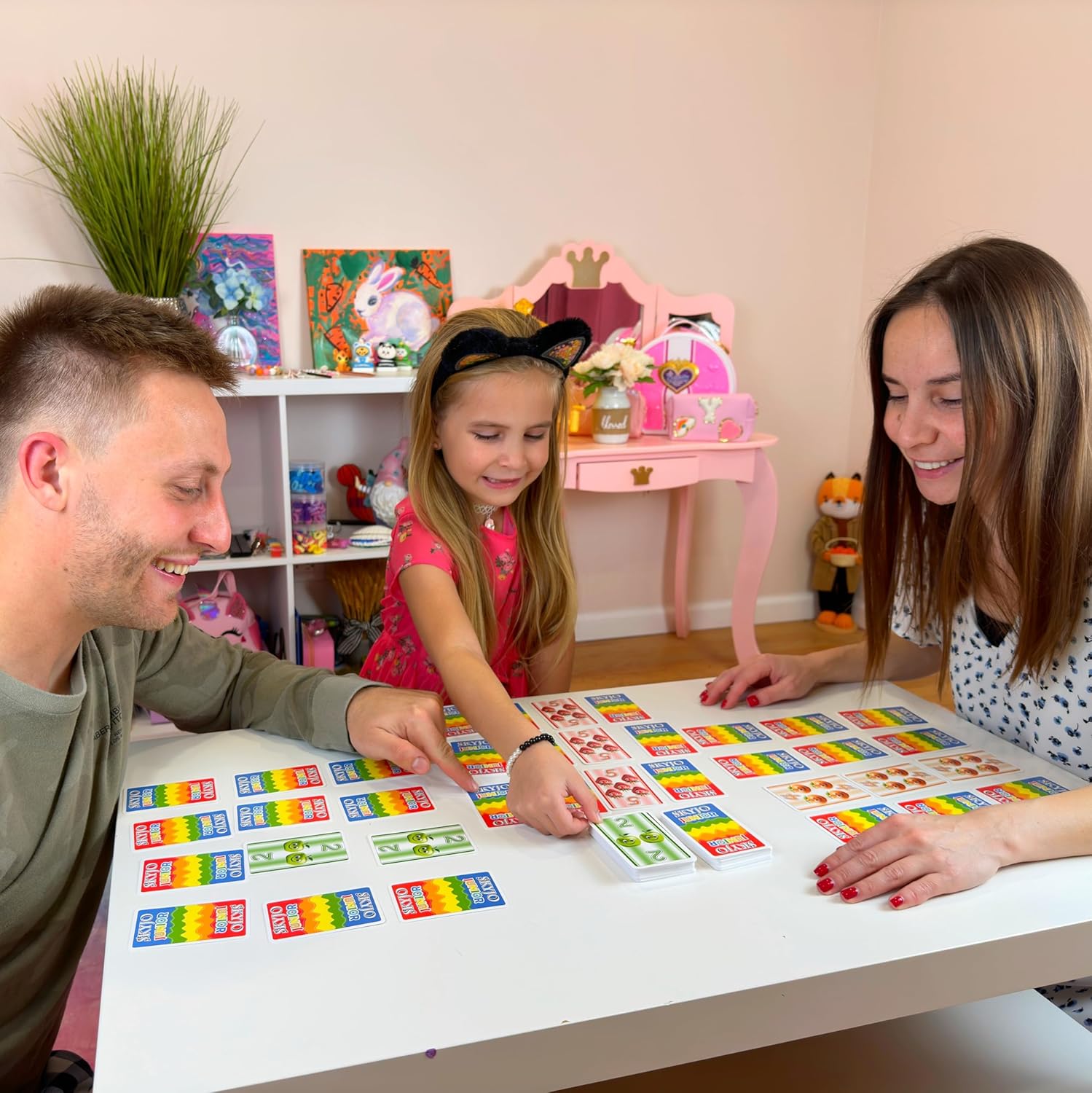 Family setting up and playing SKYJO Junior