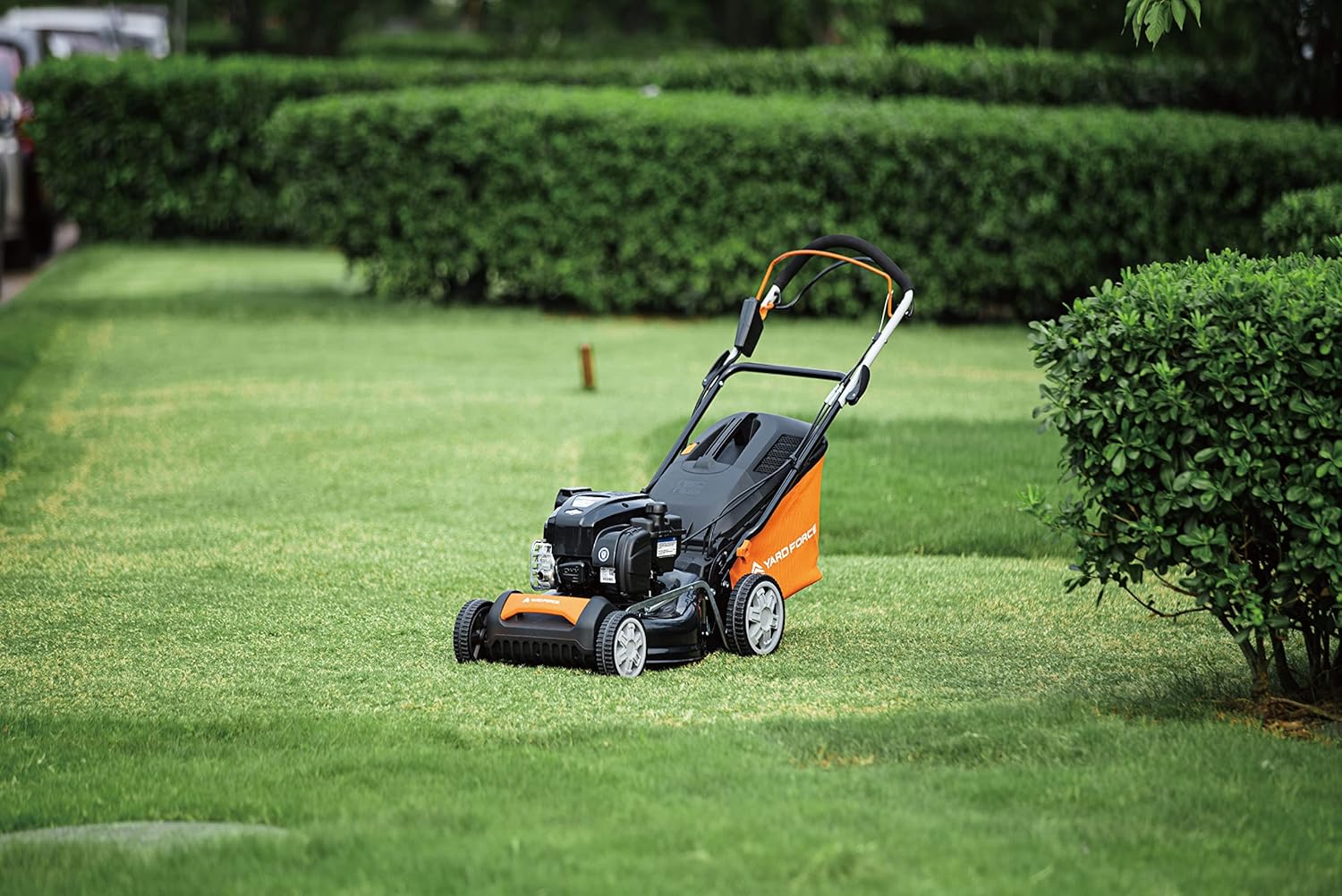 Yard Force lawn mower operating on a green lawn