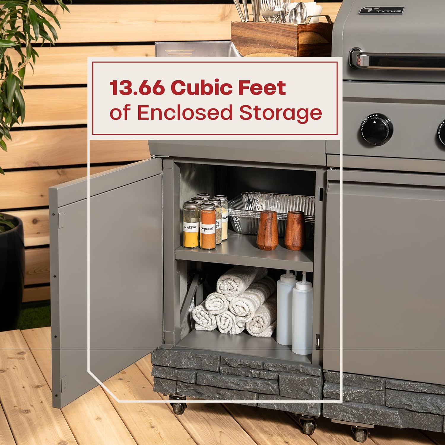 Open cabinet of the grill showing storage space for towels and spices.