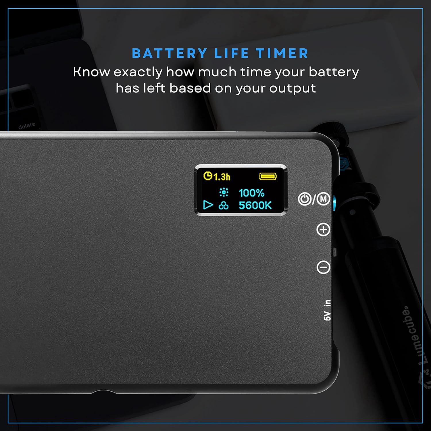 A close-up of the Lume Cube light's rear display, showing battery life (1.3h, 100%) and color temperature (5600K).