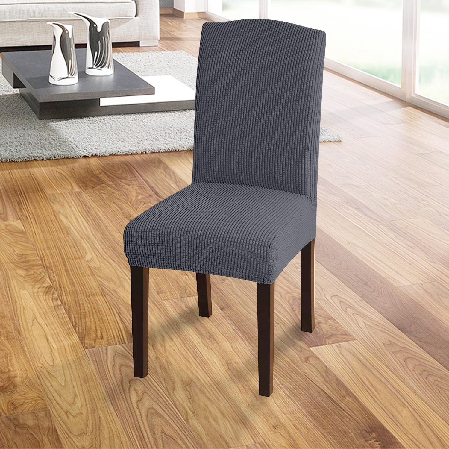 Close-up of the grey Granbest High Stretch Dining Chair Slipcover demonstrating the textured fabric and elasticated hem.