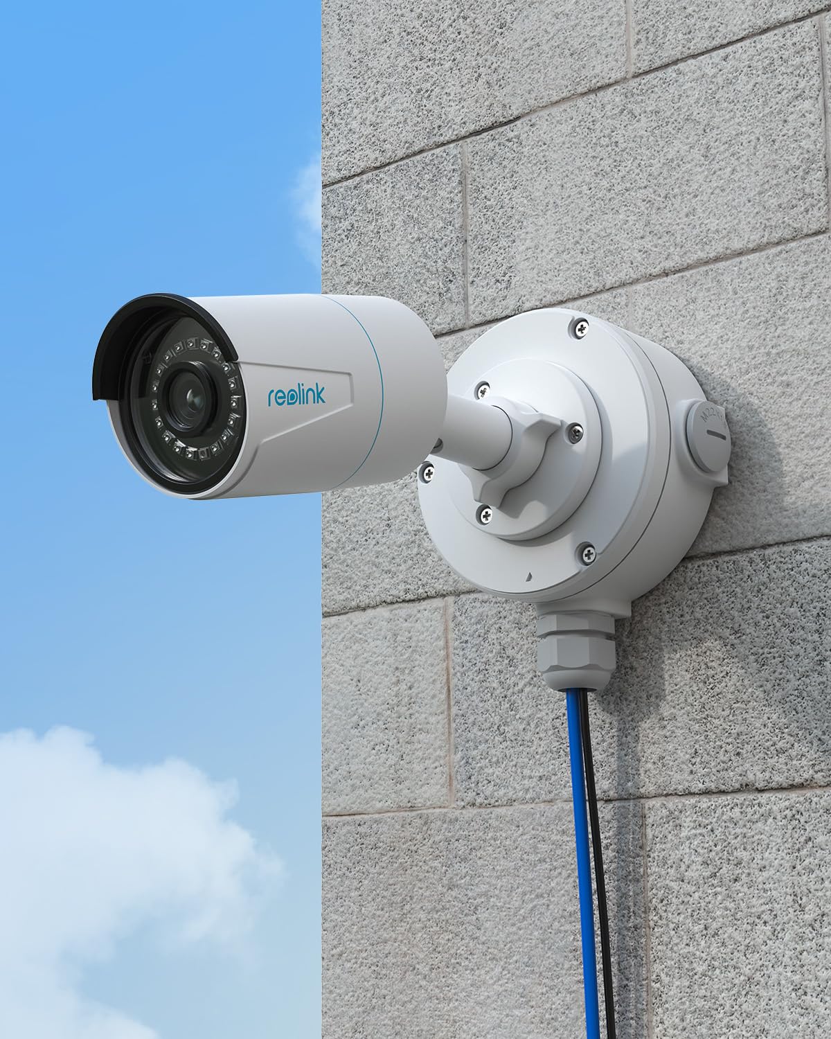 A white Reolink bullet camera mounted on a white B10 junction box, which is securely attached to a light grey brick wall. A blue network cable and a black power cable emerge from the bottom of the junction box, running downwards.