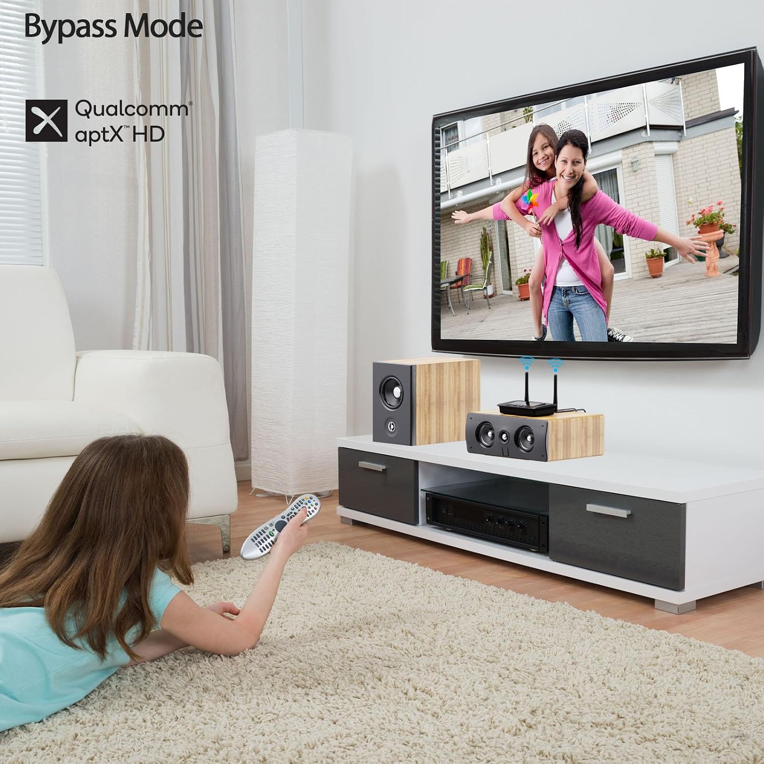 A child watching TV with the 1Mii B03Pro connected to a soundbar, illustrating the bypass mode where audio passes directly to wired speakers.
