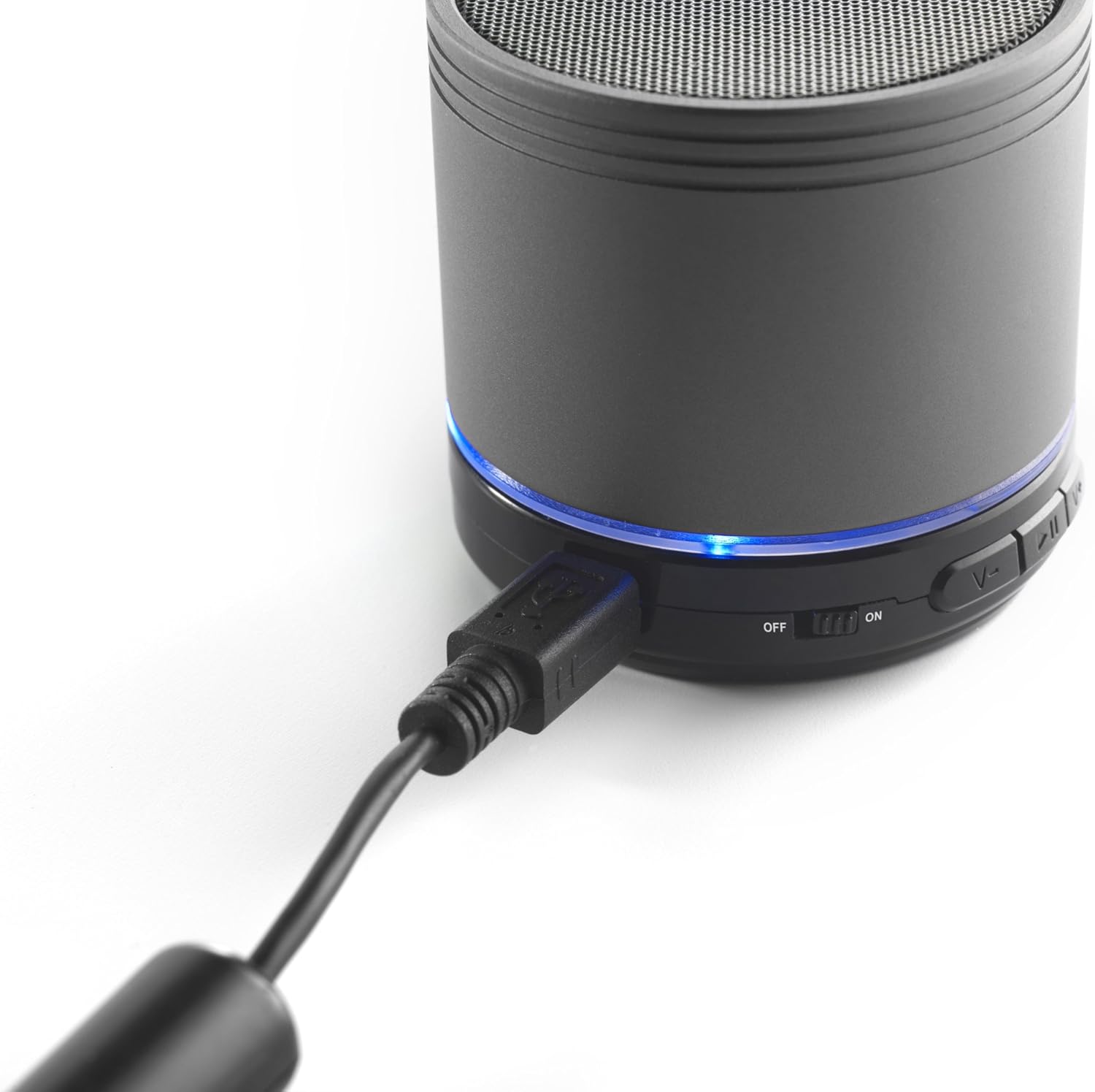 Close-up of the iCES IBT-1 speaker with a mini USB charging cable plugged into its USB port.