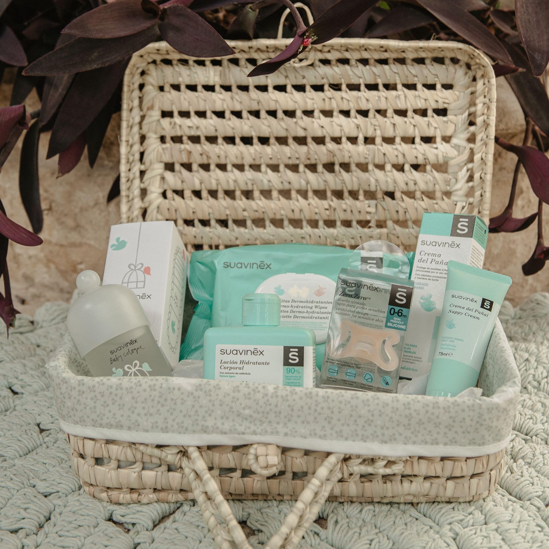 Suavinex, Regalo Bebé Recien Nacido, Canastilla Bebé con Maleta de Mimbre, Incluye: Chupete Zero Zero 0/6 Meses + Baby Cologne 100 ml + Crema del Pañal 75 ml + Toallitas + Loción Hidratante 300 ml