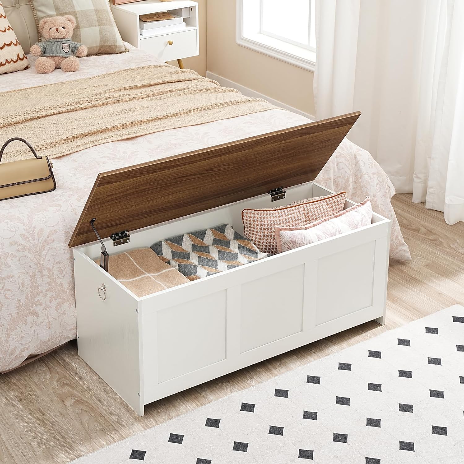 HOOBRO Storage Bench with its lid open, revealing a spacious interior filled with blankets and pillows, positioned next to a bed.