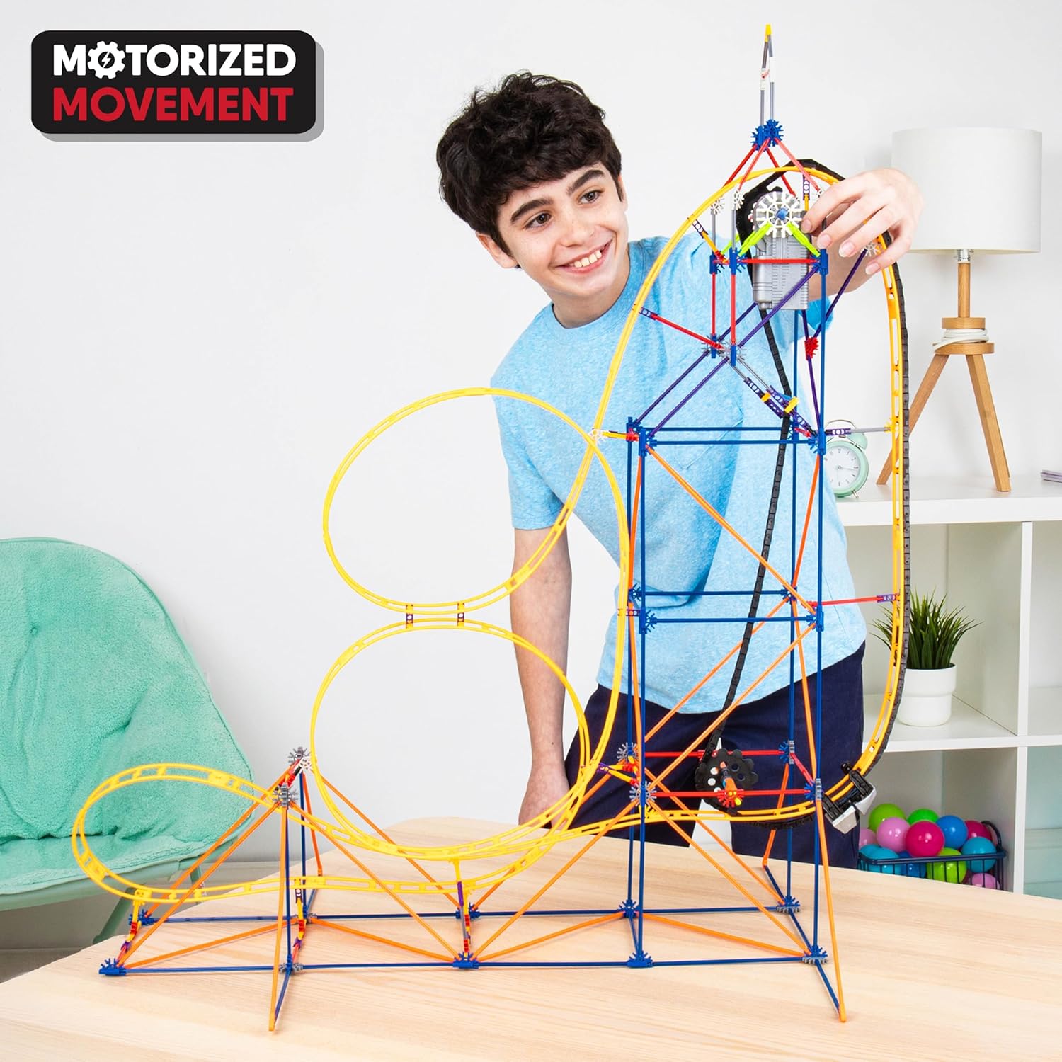 Child playing with assembled K'NEX coaster