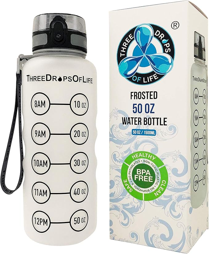 Three Drops of Life frosted 50 oz water bottle with hourly hydration markers from 8AM to 12PM in 10 oz increments, shown next to its branded packaging. The bottle features a flip-top lid, carrying strap, and is labeled BPA-free, non-toxic, and phthalate-free.