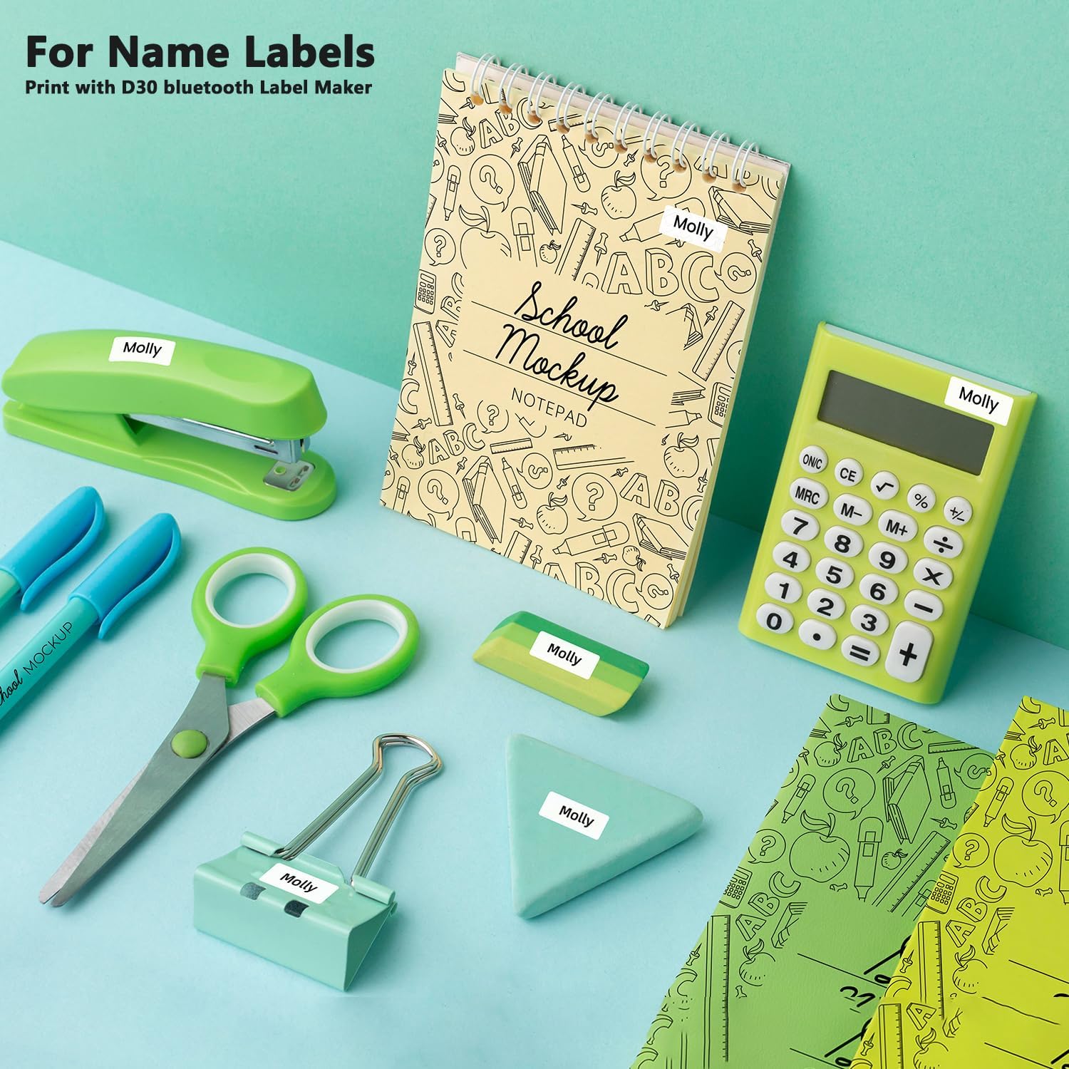 Various items like a stapler, calculator, and notebook with small white labels printed by the Phomemo D30.