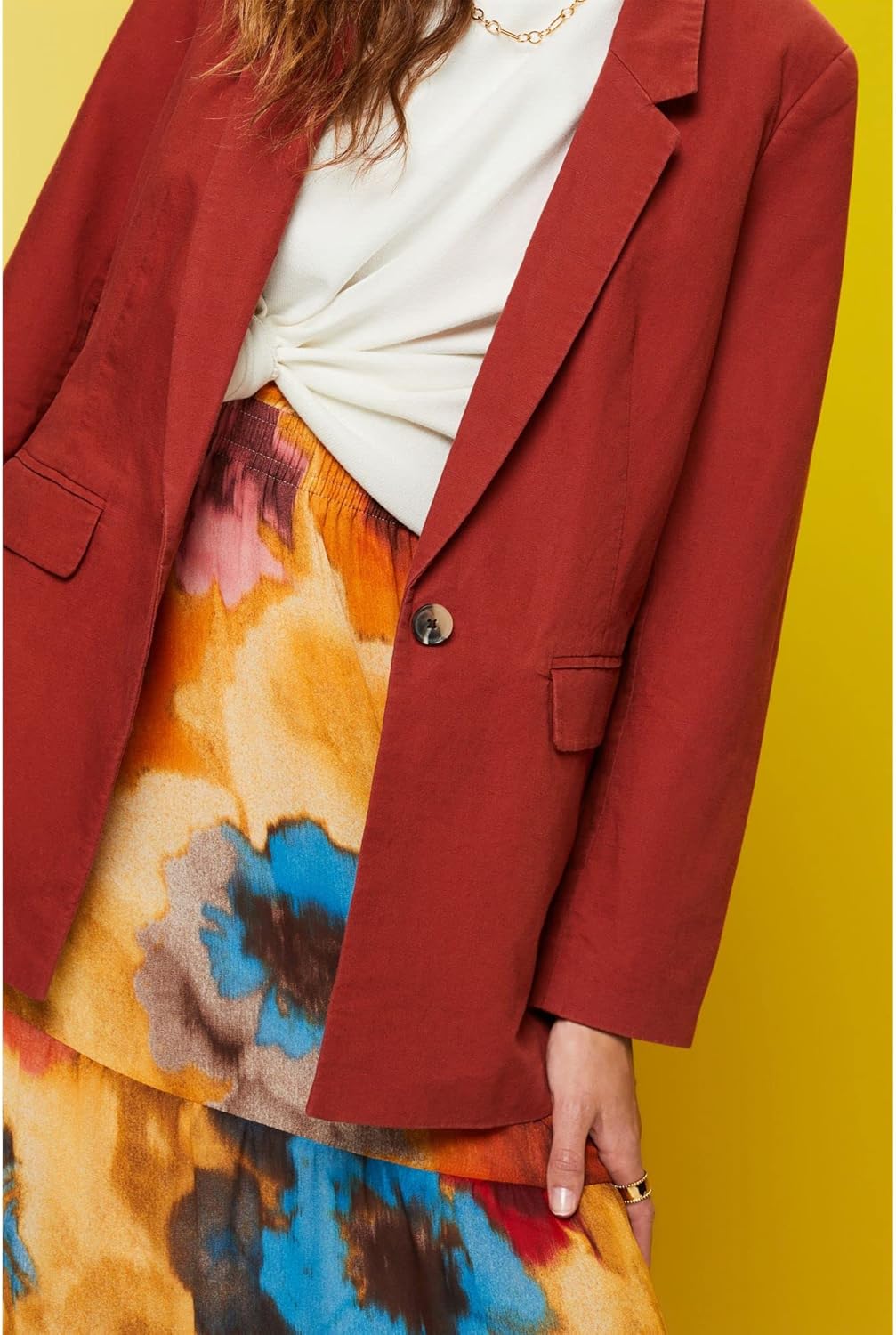 Close-up of the ESPRIT Women's Blazer being worn, showing the texture of the terracotta fabric and the single button closure.